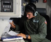 Senior Airman Marc Anderson, 326th Airlift Squadron loadmaster, completes weights and balances paperwork to ensure the aircraft is properly balanced for flight prior to take off Aug. 22 to 8 Wing Canadian Forces Base Trenton in Ontario. Reservists spent Aug. 22-24 with Royal Canadian Air Force members to forge a partnership and identify future training opportunities for flying, aerial port, airlift control and maintenance operations. (U.S. Air Force photo/Capt. Marnee A.C. Losurdo)