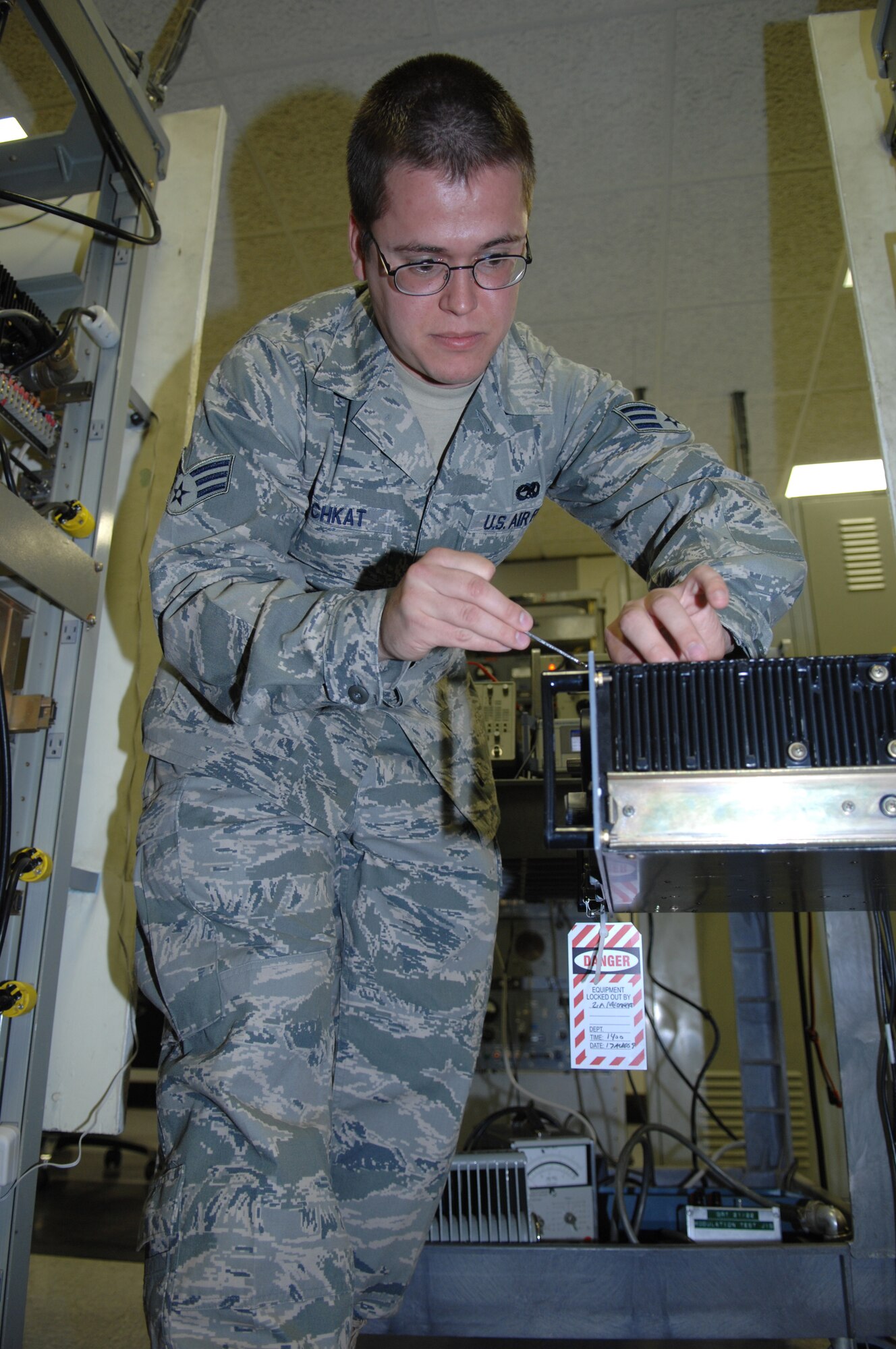 MINOT AIR FORCE BASE, N.D. -- Senior Airmen Steven Meschkat, 5th Communications Squadron, airfields systems technician replaces a driver in a ground radio transmitter here on Minot Air Force Base Aug. 16.  The ground radio transmitter serves as an air traffic radio to tell the B-52’s about weather and runway conditions. (U.S. Air Force photo by Staff Sgt. Stacy Moless)