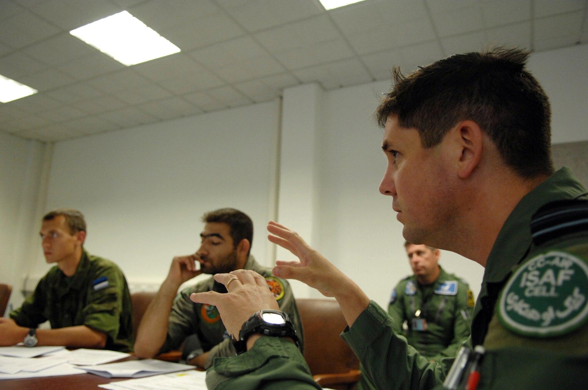 Royal Air Force Squadron Leader Keven Gambold (right) from the NATO CC-Air Ramstein International Security Assistance Force Cell conducted pre-deployment briefings for forward air controllers who call in air strikes during close-air-support operations. Two Estonian air force members and a Swedish army ranger spent a week in pre-deployment briefings, computer simulation, and field training prior to deployment thanks to the joint efforts of the staff at the USAFE AGOS and the ISAF Cell Aug. 17- 21. (U.S. Air Force photo/Master Sgt. Corey Clements) 

