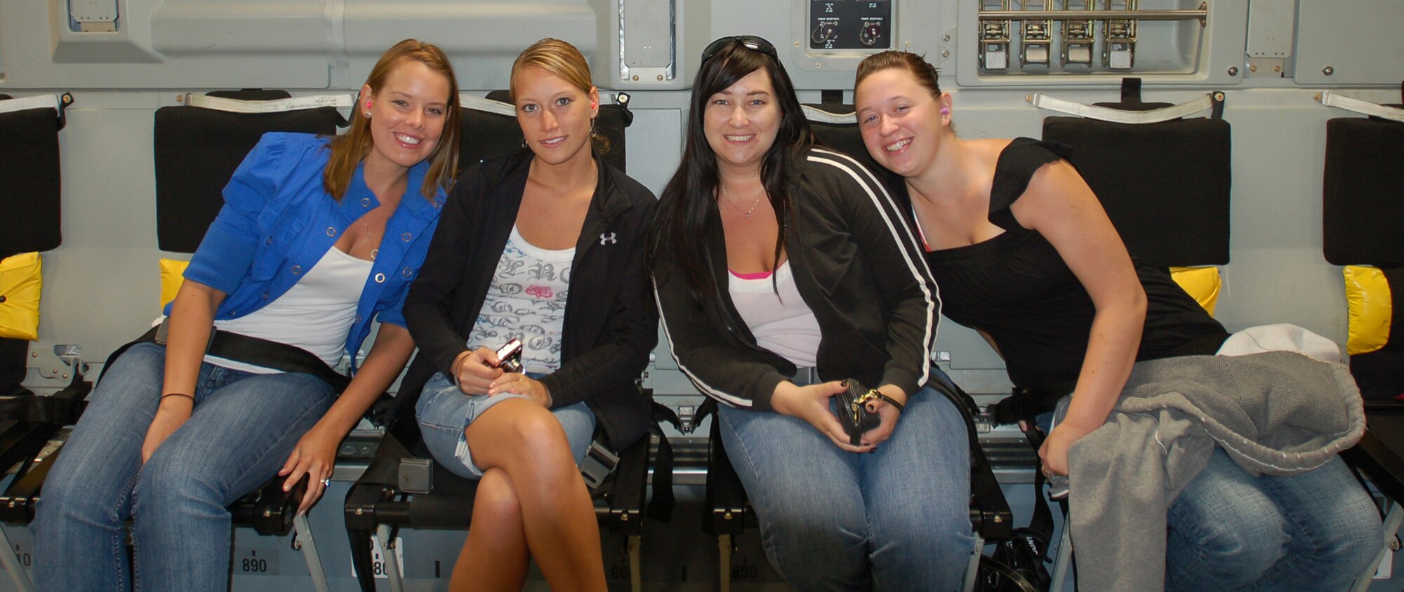 Military spouses (left to right) Nicole Ward, Kietha Remington, Carolyn Faulkner and Rhai Zasada, pose for a photo during an orientation flight on board a C-17 Globemaster III, July 28. The spouses and honorary commanders learned about the capabilities of the C-17 firsthand during the flight. (U.S. Air Force photo/2nd Lt. Abigail Wise)