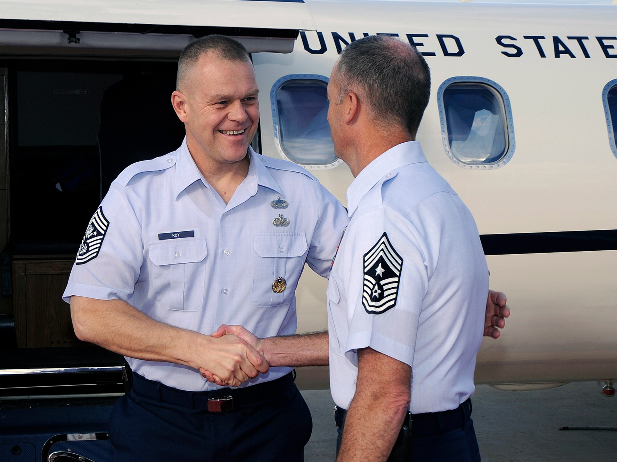 PETERSON AIR FORCE BASE, Colo. – Chief Master Sgt. of the Air Force James A. Roy (left) is greeted by Chief Master Sgt. Tim Omdal, 21st Space Wing command chief, after Chief Roy arrived at Peterson Aug. 24 to begin a four day visit to the local area. Along with his Peterson stop, Chief Roy will also visit Airmen at Schriever AFB, Cheyenne Mountain Air Force Station and F.E Warren AFB. During Chief Roy’s Peterson visit, he attended a 21st SW mission brief and hosted a Chief’s Call at the base auditorium Aug. 25. The purpose of Chief Roy’s visit is to meet with the enlisted force. (Air Force photo by Craig Denton)