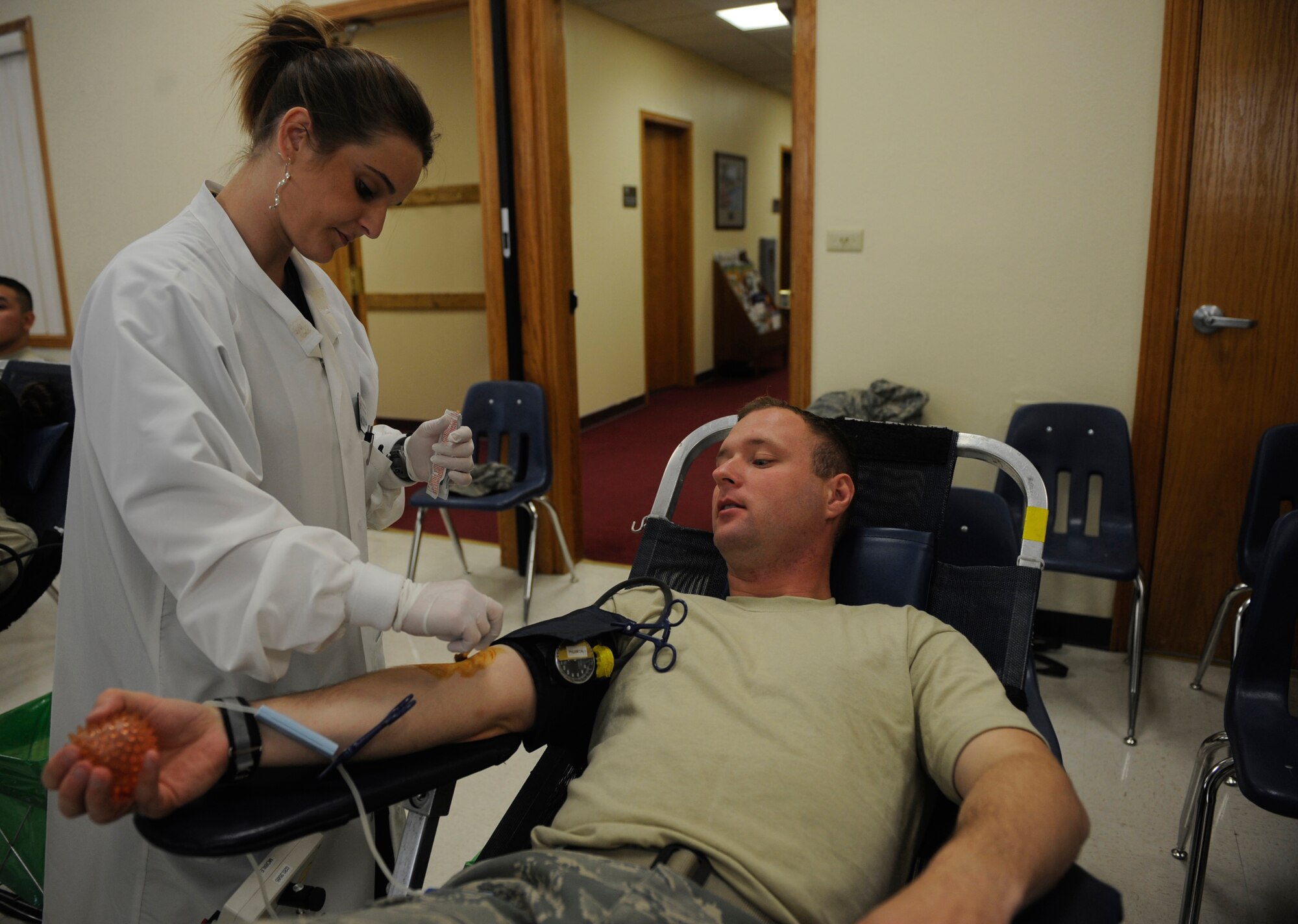MOUNTAIN HOME AIR FORCE BASE, Idaho-- Staff Sgt. Eric Norris, 366th Logistics Readiness Squadron mix facilities, lays back in his chair as Kierra Schnitker, Red Cross technician, disinfects his arm with iodine Aug. 19. The 366th Fighter Wing hosted a blood drive for the American Red Cross and collected 113 units of blood, beating the previous record of blood donated in one day by three. (U.S. Air Force photo by Airman 1st Class Renishia Richardson)