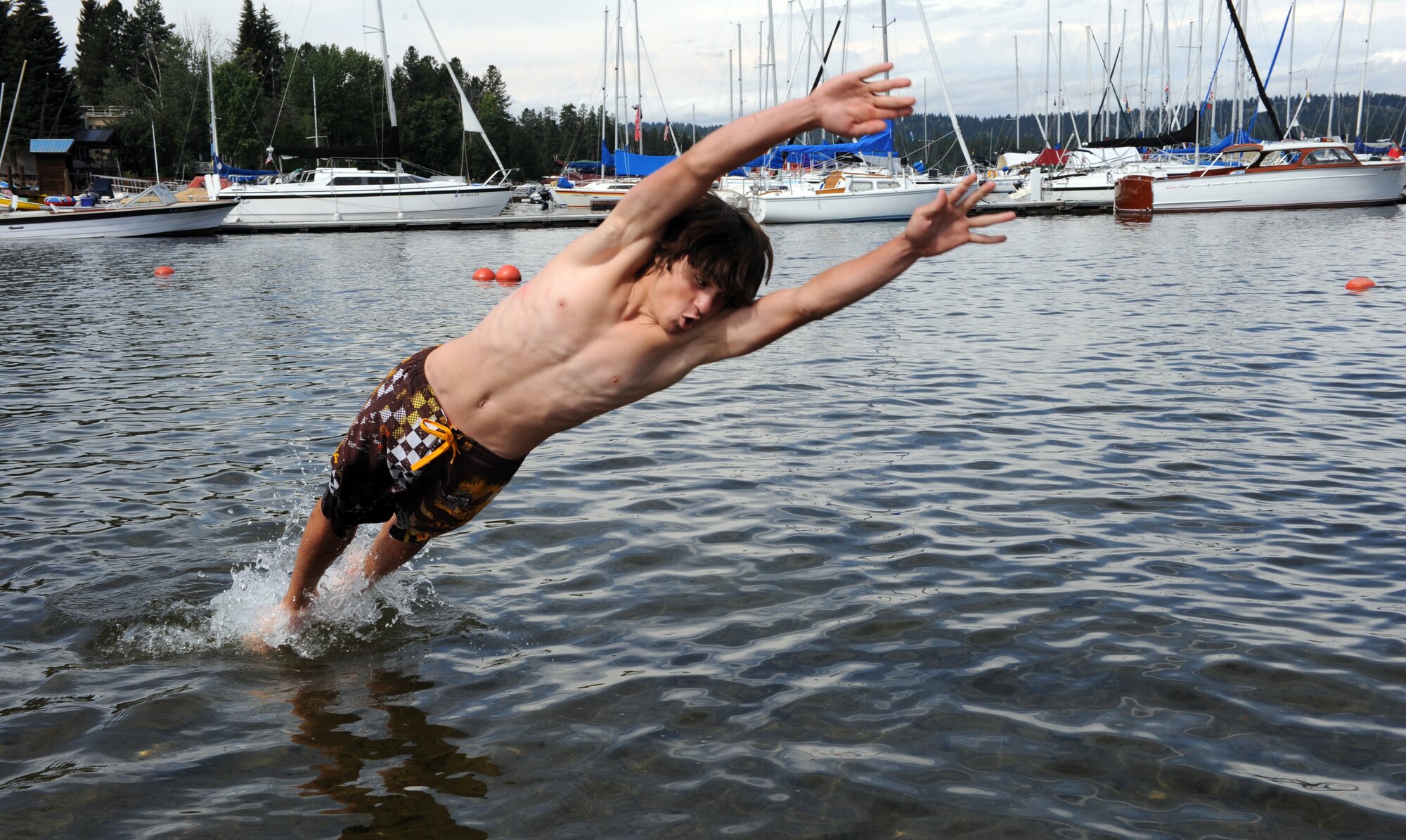 MOUNTAIN HOME AIR FORCE BASE, Idaho -- Colby Hall, camp participant, dives into a lake Aug. 11 during Operation Purple Camp in McCall, Idaho. According to www.nmfa.org, more than 155,000 children have at least one parent deployed in support of the War on Terrorism, and during the week of Aug. 9 through 15, 46 of those boys and girls learned coping methods during Mountain Home Air Force Base’s fifth OPC held in Donnelly, Idaho. (U.S. Air Force photo by Airman 1st Class Debbie Lockhart)