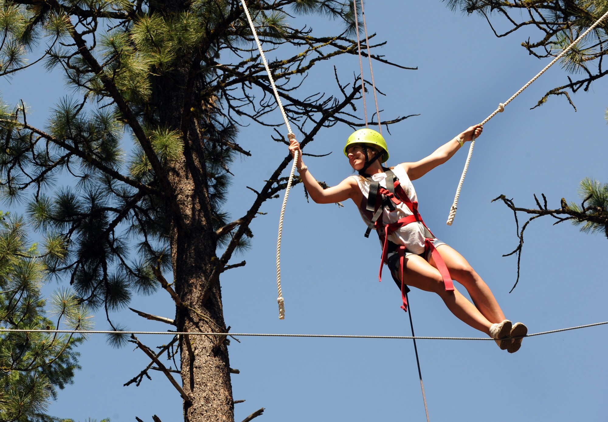 MOUNTAIN HOME AIR FORCE BASE, Idaho -- Allie Bashore, camp participant, makes her way across a high-ropes course obstacle Aug. 11 during Operation Purple Camp in Cascade, Idaho. According to www.nmfa.org, more than 155,000 children have at least one parent deployed in support of the War on Terrorism, and during the week of Aug. 9 through 15, 46 of those boys and girls learned coping methods during Mountain Home Air Force Base’s fifth OPC held in Donnelly, Idaho. (U.S. Air Force photo by Airman 1st Class Debbie Lockhart)