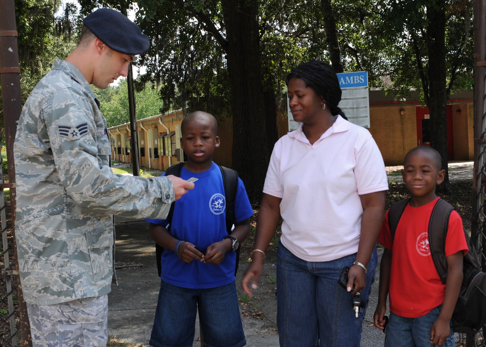 Senior Airman Ryan Booth checks identification cards at the Lambs Elementary School gate here Aug. 21. The gate is open three times a day to accommodate various school schedules, manned by a security forces member to ensure a safe environment for students and to prevent unauthorized access to the installation. Airman Booth is a patrolman with the 437th Security Forces Squadron. (U.S. Air Force photo/Senior Airman Katie Gieratz)