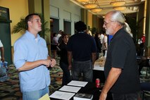TSgt Max Langford, Boom Operator for the 927th Operation Group, speaks to an Employer Support of the Guard and Reserve (ESGR) Representative about his upcoming deployment at the Yellow Ribbon Conference.(USAF Photo/TSgt Denise Hauser)