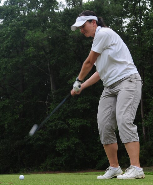 Maj. Debra Lovette, 4th Force Support Squadron commander, tees off during the Three Eagles Golf Course grand re-opening nine-hole tournament on Seymour Johnson Air Force Base, N.C., Aug. 21, 2009. Zoysia grass was planted in the course's shady areas because it grows like a thick carpet and handles the foot traffic of a golf course well. (U.S. Air Force photo by Airman 1st Class Rae Perry)