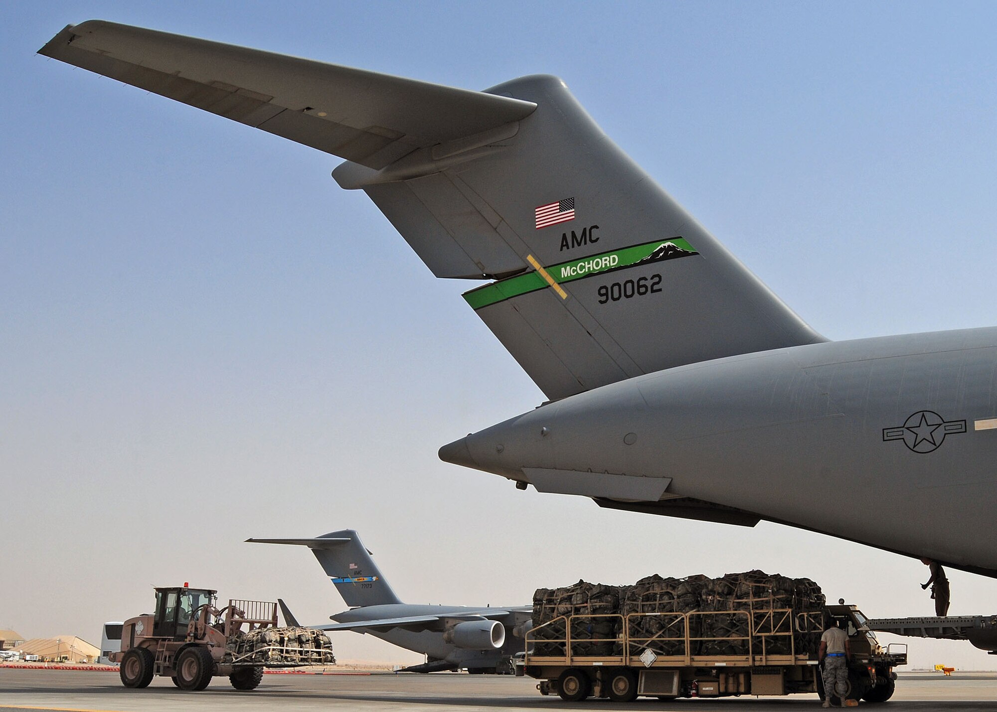 SOUTHWEST ASIA -- 386th Expeditionary Logistics Readiness Squadron 10K all terrain forklift (left) and 25K loader move into position to load a 816th Expeditionary Airlift Squadron C-17 Globemaster III on the 386th Air Expeditionary Wing parking ramp at an undisclosed location in Southwest Asia Aug. 21, 2009.  The C-17 is deployed from McChord Air Force Base, Wash.  (U.S. Air Force photo / Tech Sgt. Tony Tolley)