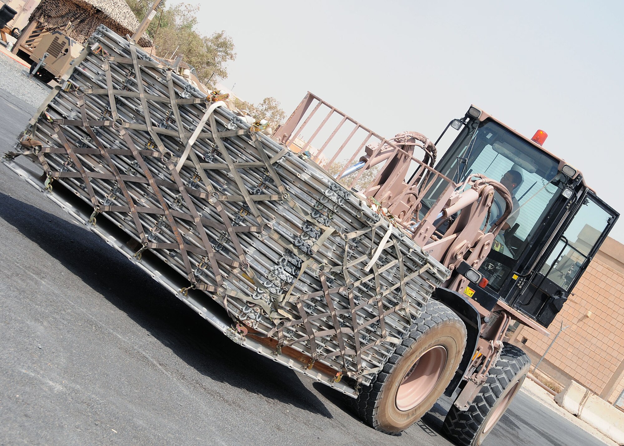 SOUTHWEST ASIA -- Senior Airman James Purdon, 386th Expeditionary Logistics Readiness Squadron ramp services specialist, operates a 10K all terrain forklift while hauling pallets at an undisclosed location in Southwest Asia Aug. 21, 2009.  In a given day, the 386th LRS Aerial Port Flight will move more than 200 short-tons of cargo.  Airman Purdon is deployed from the 436th Airlift Wing, Dover Air Force base, Del.  (U.S. Air Force photo / Tech Sgt. Tony Tolley)