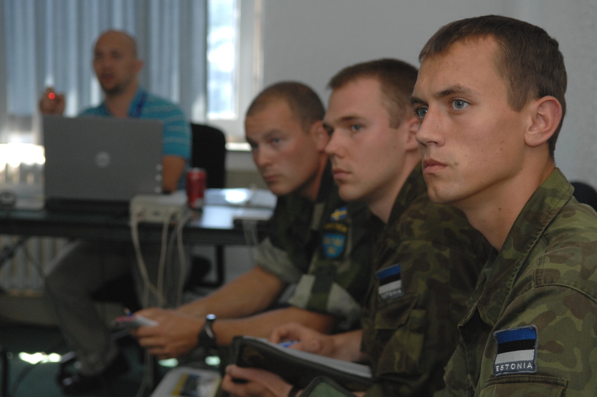 RAMSTEIN AIR BASE, Germany- Estonian air force members (r to l) Junior Sergeant David Mellov and 2nd Lt. Evo Koiv and Swedish army ranger Capt. Timothy Walsh watch a demonstration of a computer simulator at the U.S. Air Forces in Europe Air Ground Operations School used for practicing air strikes during close air support operations.  The forward air controllers spent a week in pre-deployment briefings, computer simulation, and field training prior to deployment thanks to the joint efforts of the staff at the USAFE AGOS and the International Security Assistance Force Cell at NATO Allied Air Component Command Headquarters Ramstein Aug. 17- 21. (U.S. Air Force photo/Master Sgt. Corey Clements)