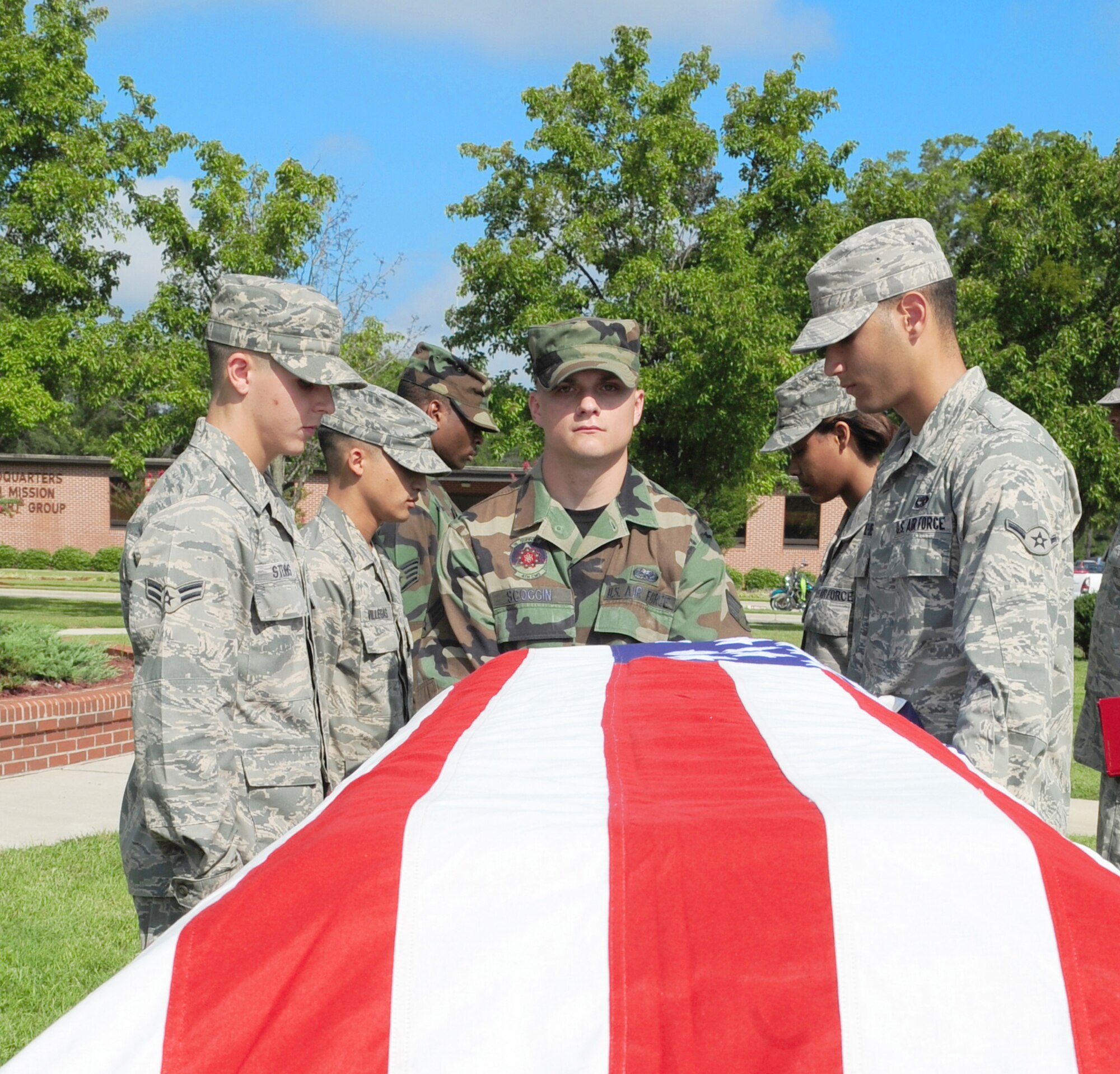 Honor guard Airmen from the 4th Fighter Wing and Charlotte Air National Guard perform a mock military funeral during a graduation ceremony at Seymour Johnson Air Force Base, N.C., Aug. 19, 2009. Airmen from the Air Force Honor Guard traveled to Seymour Johnson to train and qualify the class for 10 days on proper funeral procedures. The 29 members will serve on their respective honor guard team for a year.  (U.S. Air Force photo by Airman 1st Class Rae Perry)