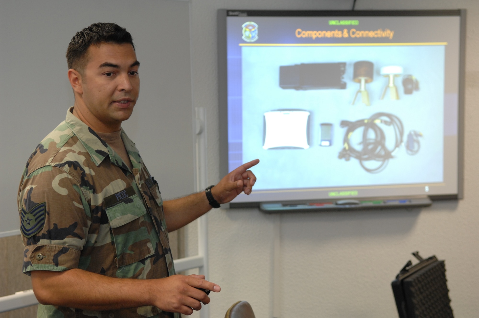 RAMSTEIN AIR BASE, Germany- Tech. Sgt. Nicholas Picoc, who is in charge of training and evaluations at the U.S. Air Forces in Europe Air Ground Operations School, briefs international forward air controllers on upgrades to the ROVER III, a kit which mainly consists of a tactical laptop, antennas, cables and other items used to receive live video feed from aircraft during close air support operations.  Two Estonian air force members and a Swedish army ranger spent a week in pre-deployment briefings, computer simulation, and field training prior to deployment thanks to the joint efforts of the staff at the USAFE AGOS and the International Security Assistance Force Cell at NATO Allied Air Component Command Headquarters Ramstein Aug. 17- 21. (U.S. Air Force photo/Master Sgt. Corey Clements)