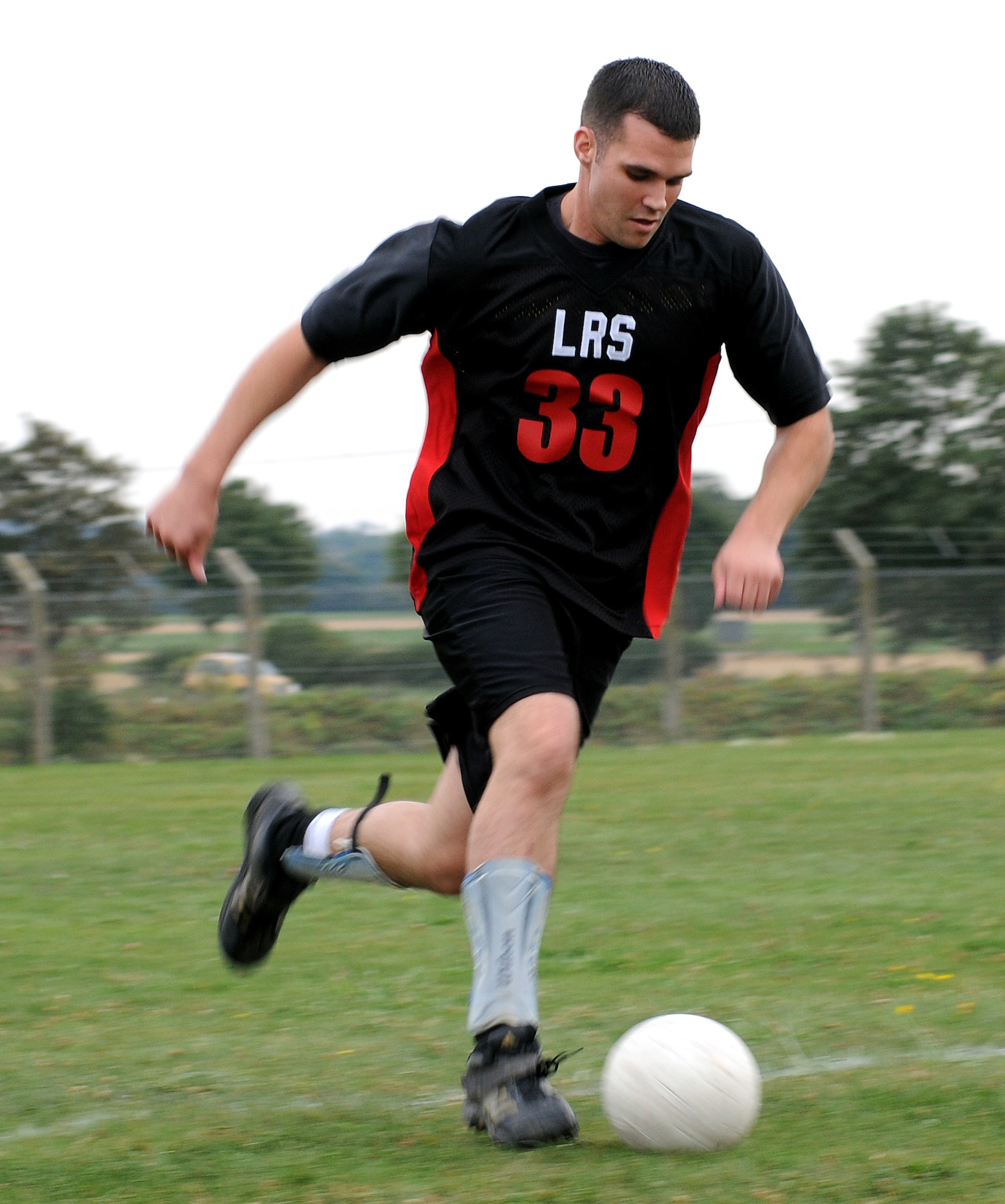 RAF MILDENHALL, England -- Forward Ray Wisdom, 100th Logistics Readiness Squadron, dribbles downfield before scoring the first goal of the 4-0 game against the 727th Air Mobility Squadron Aug. 24 at the southside soccer fields. This was the first day of play for the Mildenhall Intramural Outdoor Soccer league and a shortage of players forced the 727th AMS to forfit at halftime. Anyone interested in the league should contact the Northside Fitness Center at DSN 238-2349. (U.S. Air Force photo by Senior Airman Thomas Trower)