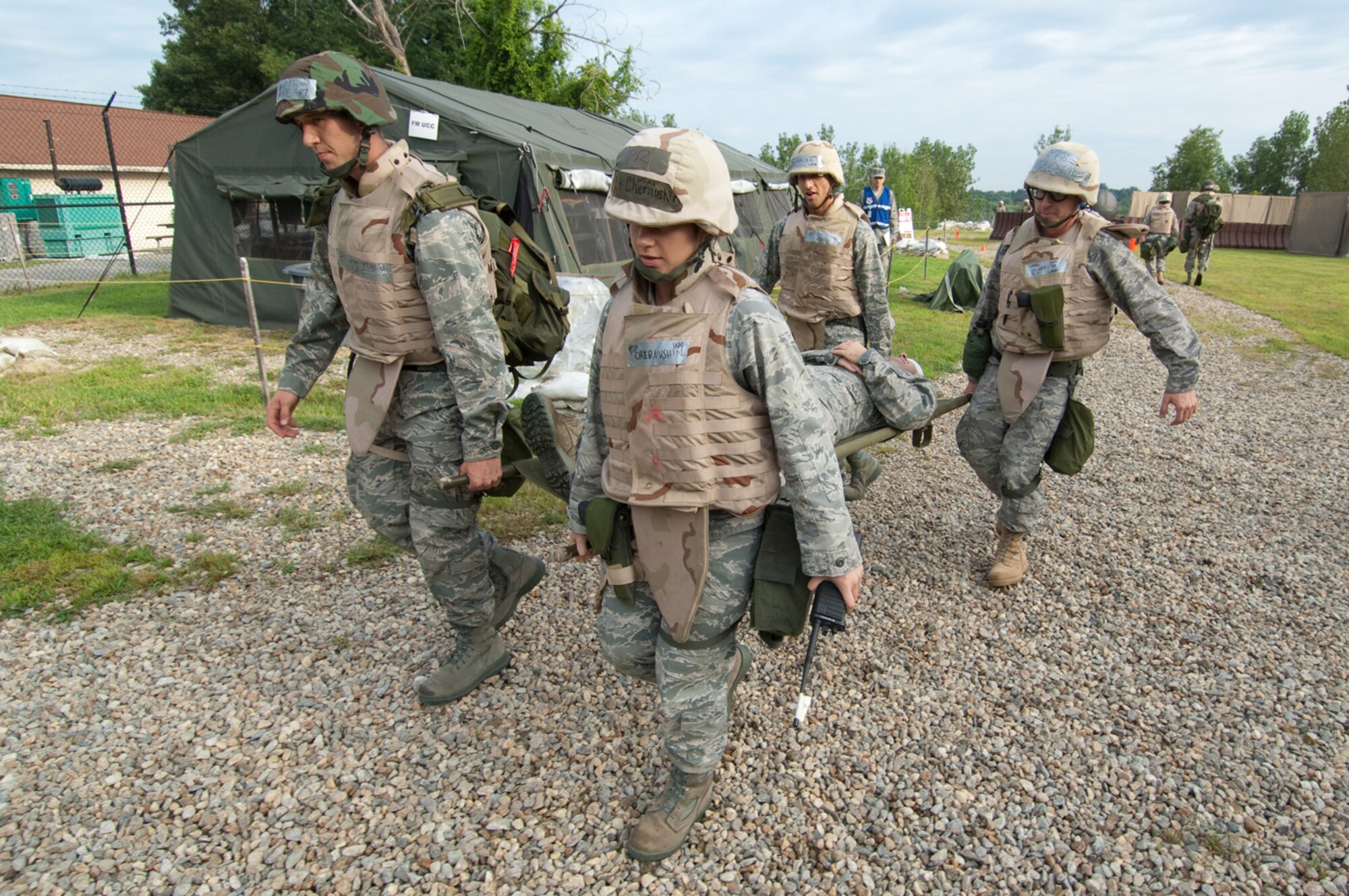 HANSCOM AIR FORCE BASE, Mass. –Hanscom Airmen perform a litter carry as part of a Self Aid and Buddy Care scenario that took place during a week-long base readiness exercise Aug. 17 to 21. The Camp Patriot portion of the BRE tested deployment readiness through simulated ground and chemical attacks at Camp Patriot, in addition to a number of other scenarios to help prepare personnel for deployed environments.  (U.S. Air Force photo by Rick Berry)