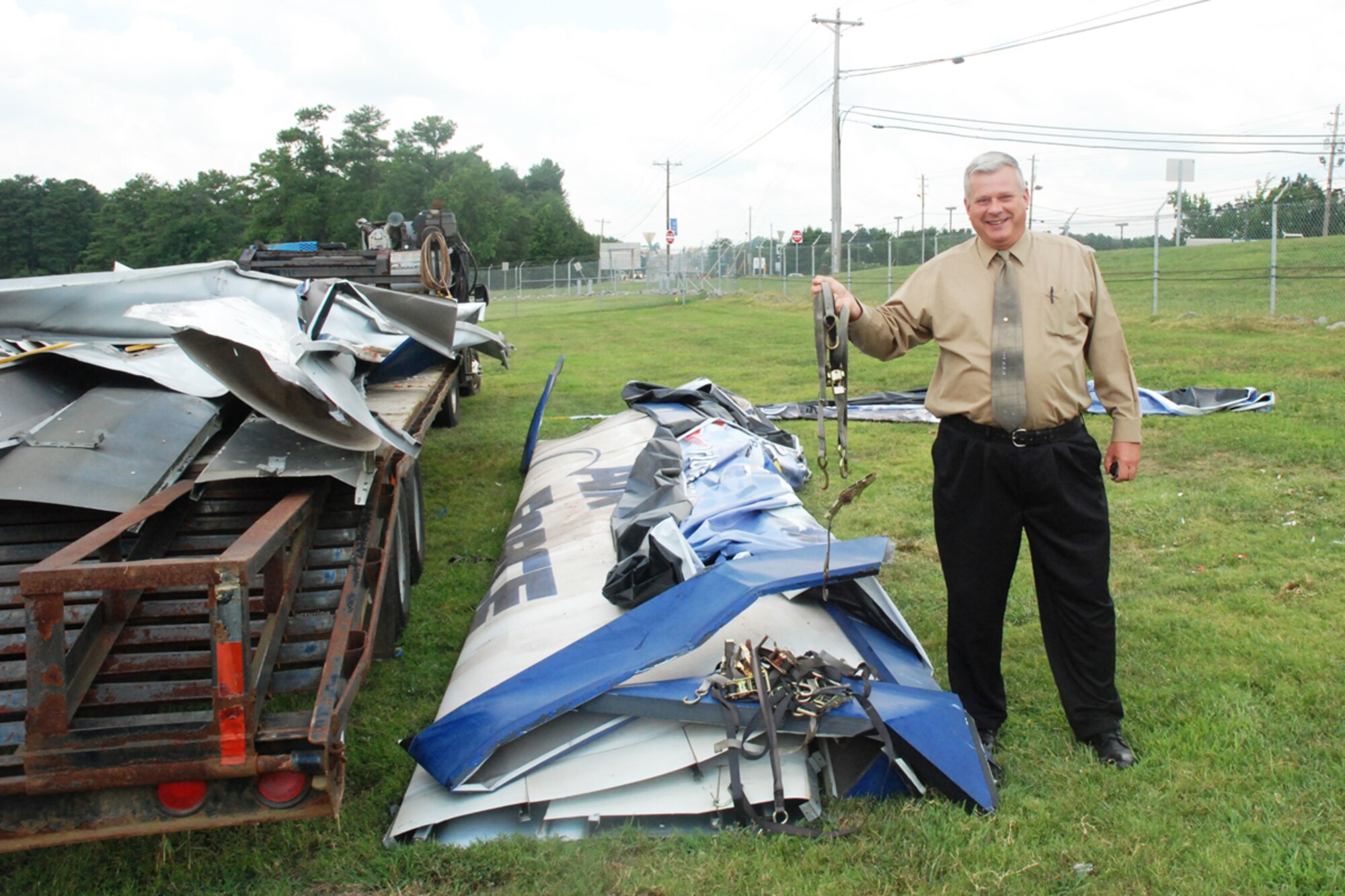 Contractors loaded pieces of the old Dobbins billboard and concrete footings onto a flat bed trailer to be hauled away Aug. 24. The sign became a safety hazard, being held together with old tie down straps and the cost to replace four signs a year rose to more than $10 thousand. (U.S. Air Force photo/Kennith Green)