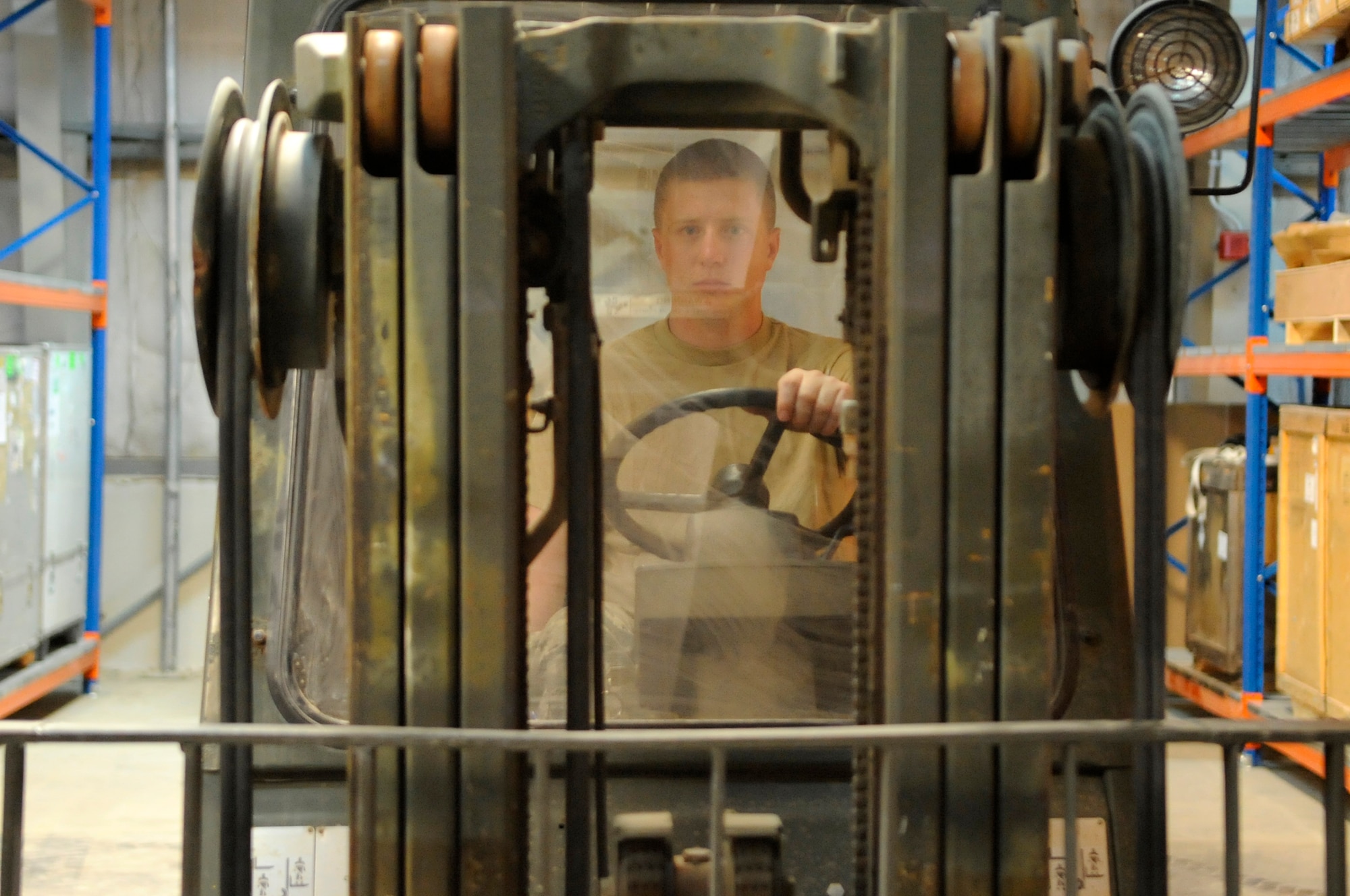SOUTHWEST ASIA, Senior Airman Garrett Wikum, 380th Expeditionary Logistics Readiness Squadron, operates a forklift while moving pallets in a supply warehouse Aug. 25. Airman Wikum is deployed from Aviano AB, Italy and hails from Rathdrum, Idaho. (U.S. Air Force photo/Senior Airman Stephen Linch) 