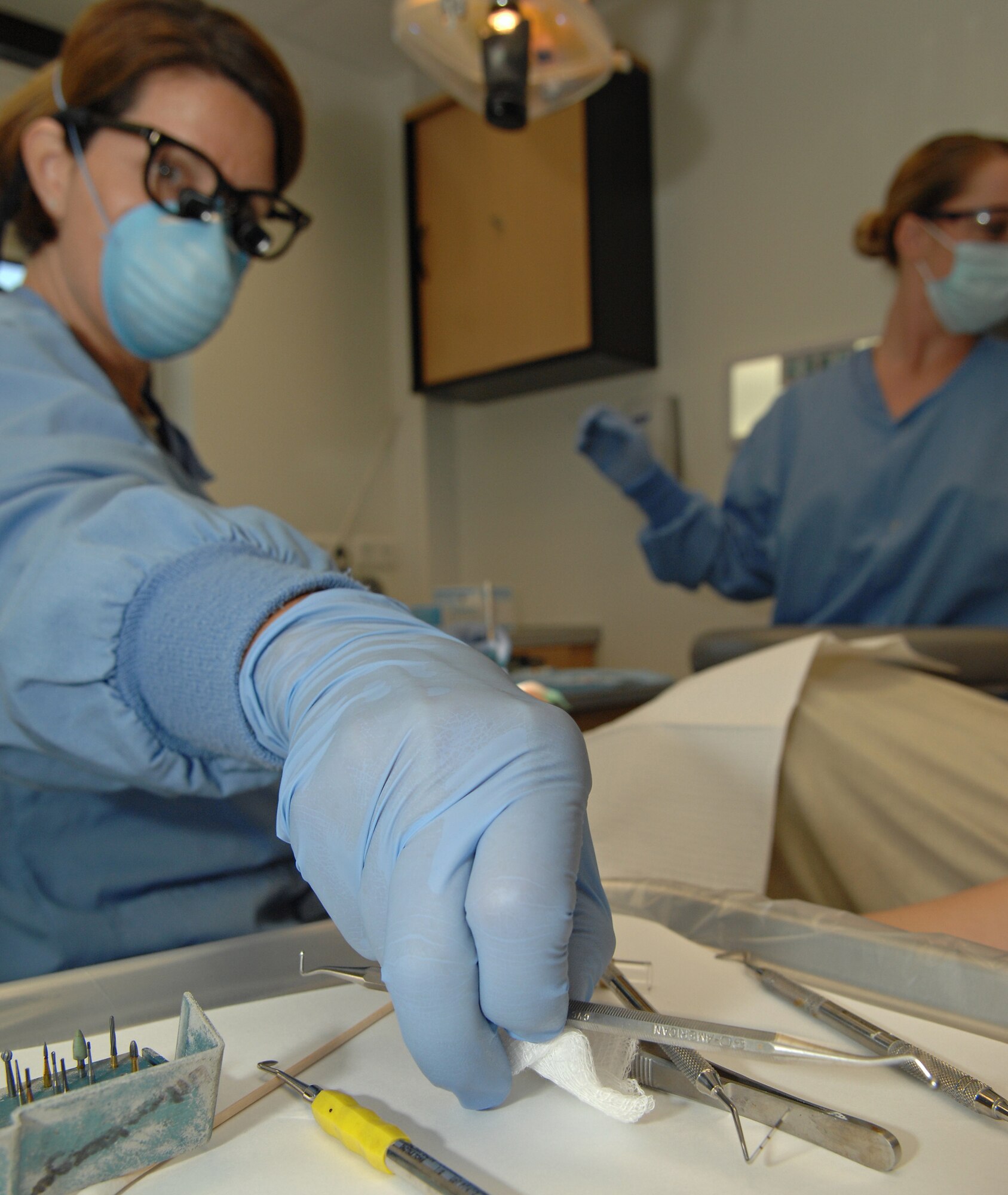 SPANGDAHLEM AIR BASE, Germany – Lt. Col. (Dr.) Holly Ellenburger, 52nd Dental Squadron, reaches for a new tool as she repairs a cavity Aug. 24. (U.S. Air Force photo/Senior Airman Benjamin Wilson)