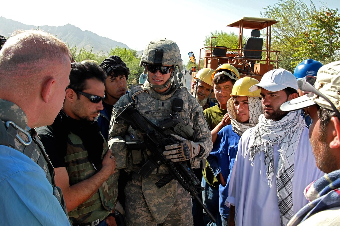 U.S. Air Force 1st Lt. Graham Auten and Army Brig. Gen. Guy L. Sands-Pingot, left, assistant inspector general for the Special Inspector General  for Afghanistan Reconstruction, visited the construction site of a damaged road in Mahmood Raqi, Afghanistan, Aug. 12, 2009. Auten is a civil engineer assigned to the Kapisa-Parwan Provincial Reconstruction Team, which is evaluating the progress of construction sites across Kapisa province.