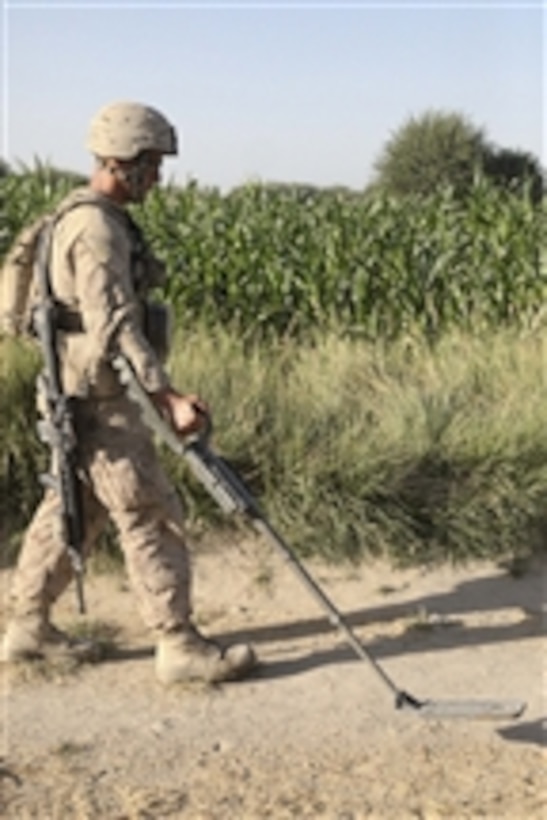 U.S. Marine Corps Lance Cpl. Daniel Bemenderfer, with Charlie Company, 1st Battalion, 5th Marine Regiment, uses a mine sweeper to search for improvised explosive devices in Nawa, Afghanistan, on Aug. 19, 2009.  The Marines are deployed with Regimental Combat Team 3 to conduct counterinsurgency operations in partnership with Afghan National Security Forces in southern Afghanistan.  