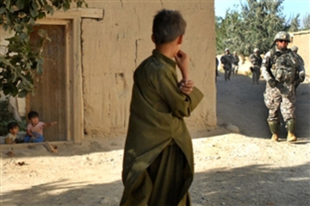 Afgan children of the Janqadam village flock to see U.S. Army soldiers and airmen during a routine check on the community’s agricultural projects outside Bagram Airfield in Parwan province, Afghanistan, Aug. 24, 2009. The soldiers and airmen are assigned to the Kentucky Agribusiness Development Team. A greenhouse and vineyard are focal projects with a goal to increase yields for the villagers, enabling them to earn extra money at nearby markets.