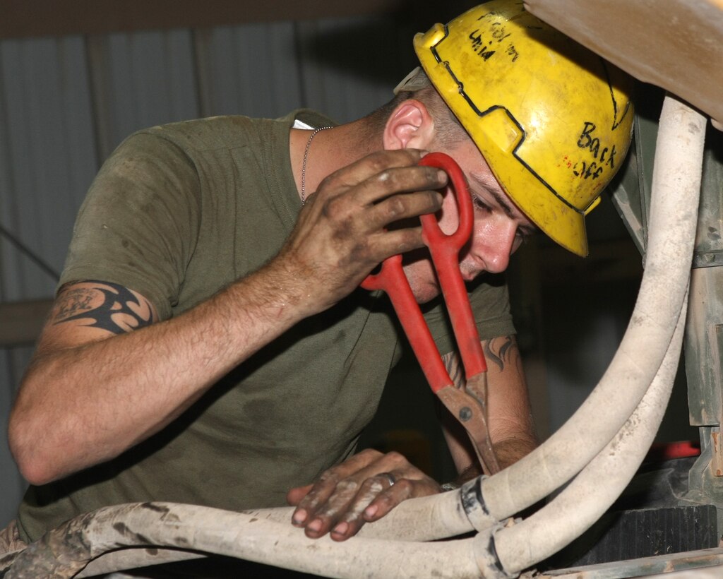 Cpl. Micheal S. Banther, a truck mechanic with Combat Logistics Battalion 22, 22nd Marine Expeditionary Unit and a native of Fort Payne, Ala., disconnects a part from a Caterpillar C-12 engine before removing it from a 7-ton truck at Camp Buehring, Kuwait, Aug. 24, 2009. The 22nd MEU is ashore in Kuwait to conduct sustainment training while serving as the theater reserve force for U.S. Central Command.