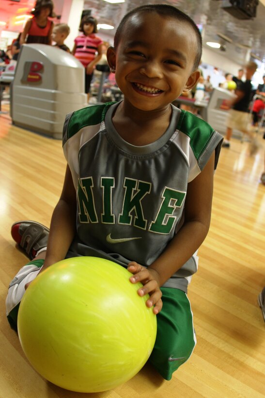 Five-year-old Devin Khaivilay patiently waits for his turn to knock down the pins Aug. 26 at Marine Unmanned Aerial Vehicle Squadron 1's back-to-school family fun day at the Combat Center's Sandy Hills Bowling Alley.