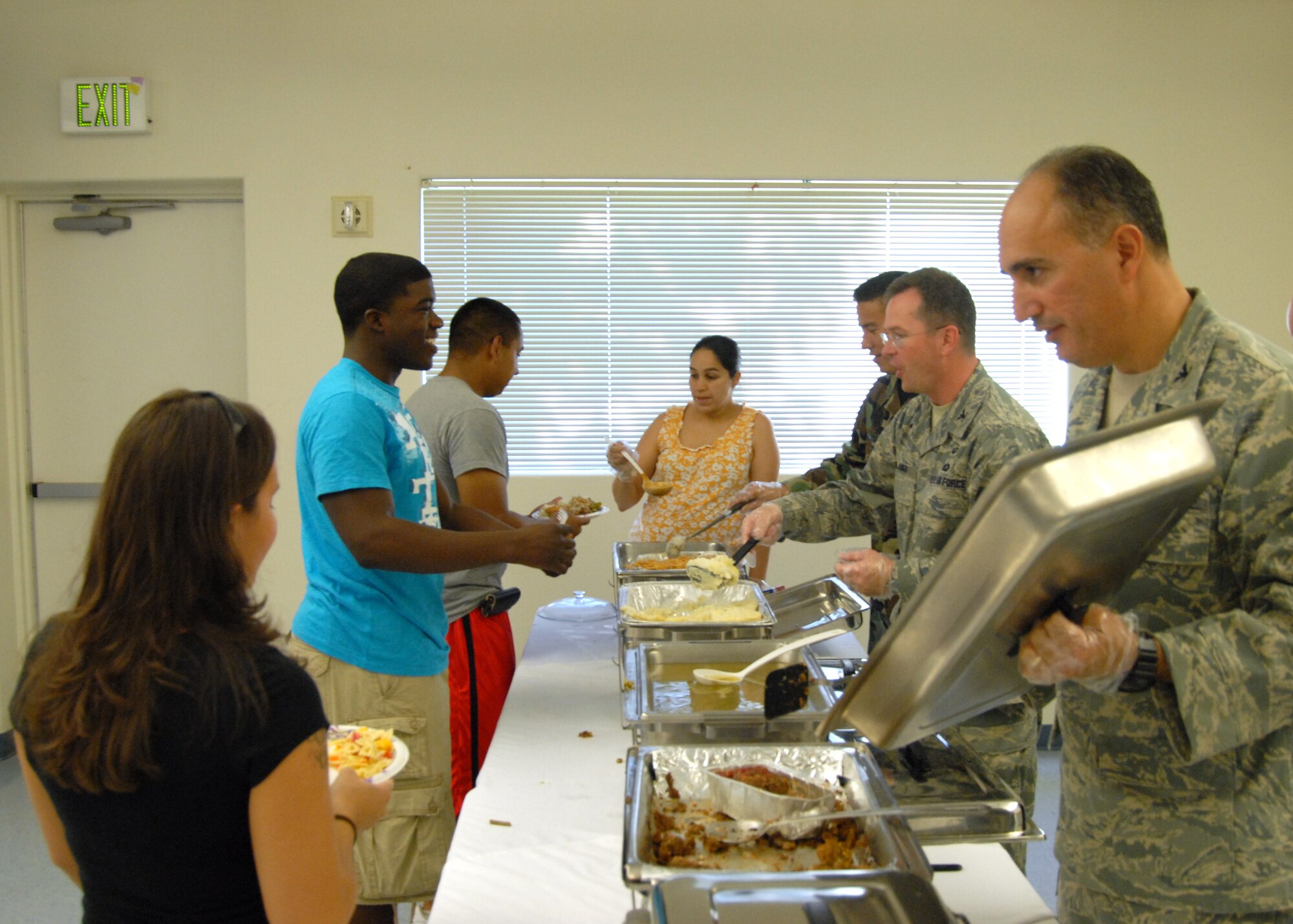 Base leadership serves food to dorm residents during the dorm dwellers dinner at the chapel 1 annex here Aug. 26. The dorm dinner was hosted by Edwards Enlisted and Officer's Spouses Clubs. The dinner was open to all dorm residents, both Air Force and Marine Corp. (Air Force photo/Airman 1st Class William O'Brien)