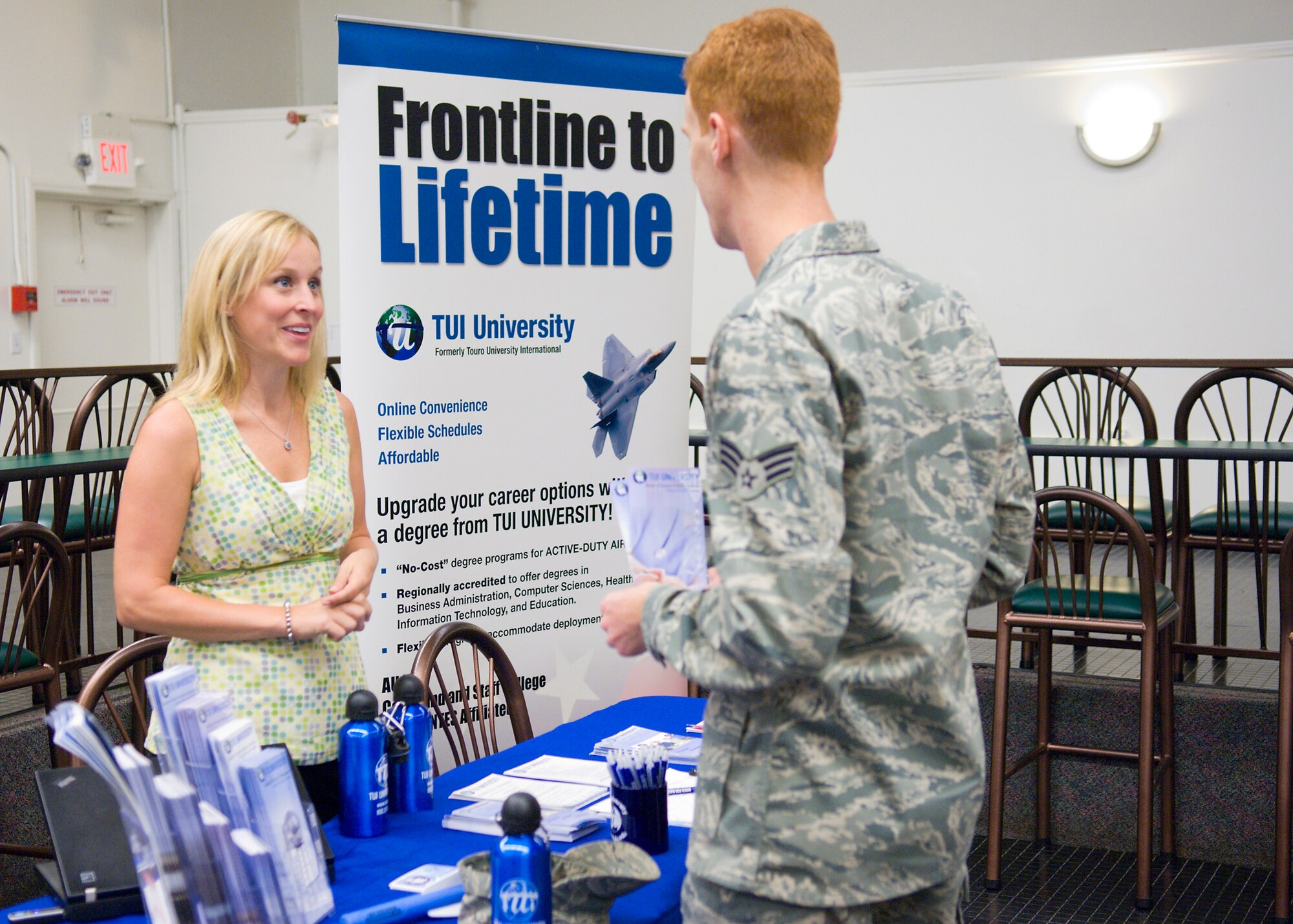 Senior Airman Keith Buehler, 95th Medical Operations Squadron, talks to a college representative during a career fair in the Oasis Community Center here Aug. 26. The career fair was open to all of Team Edwards and featured more than 30 colleges. (Air force photo/Mike Cassidy)