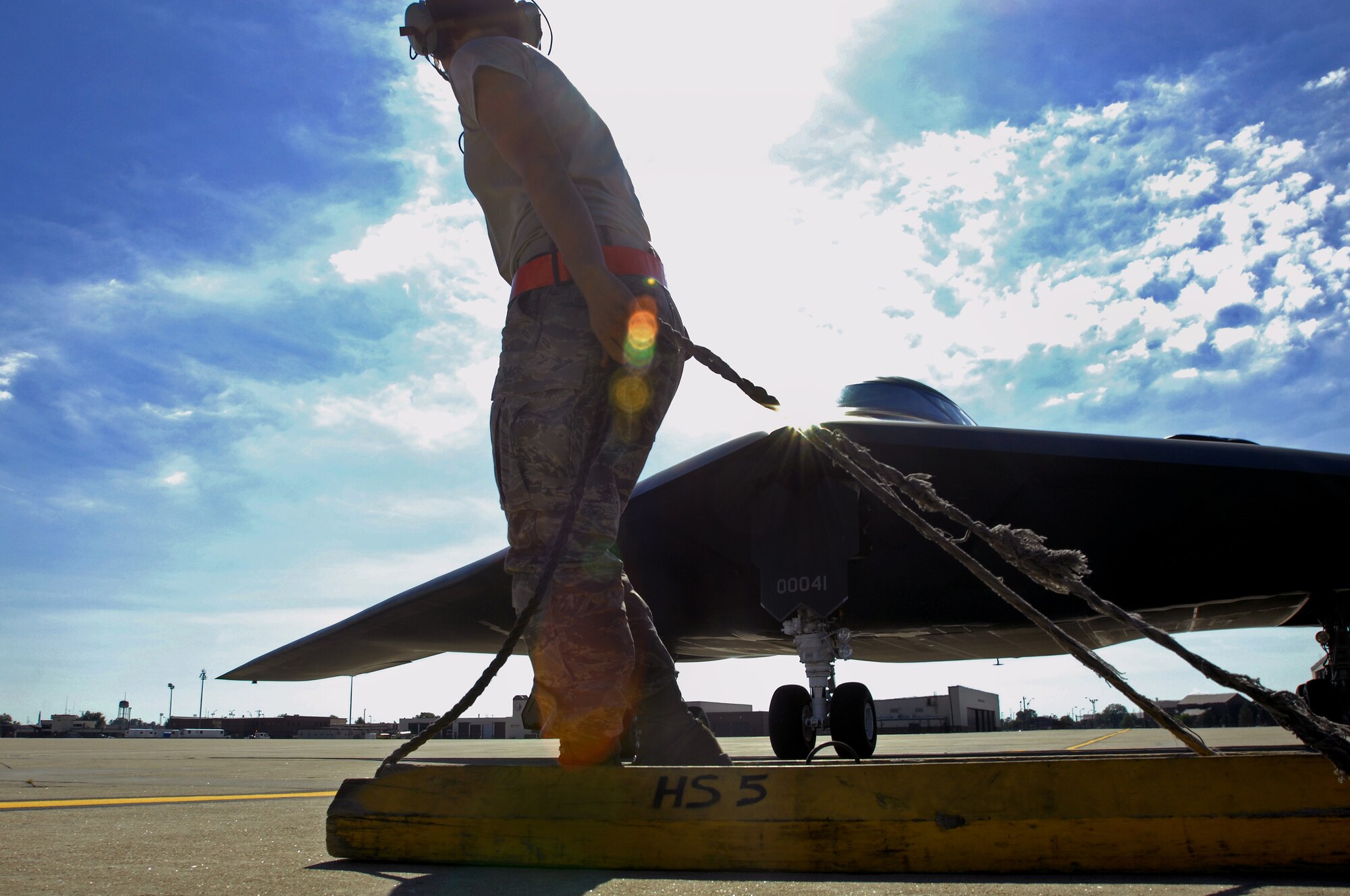 WHITEMAN AIR FORCE BASE, Mo. - Airman 1st Class Jaime Ibeh , 509th Aircraft Maintenance Squadron crew chief, pulls chalks into position beneath a B-2 Spirit, Aug. 24. 509th AMXS crew chiefs work around the clock with B-2 pilots training and staying prepared for real world missions. (U.S. Air Force photo/Senior Airman Kenny Holston)