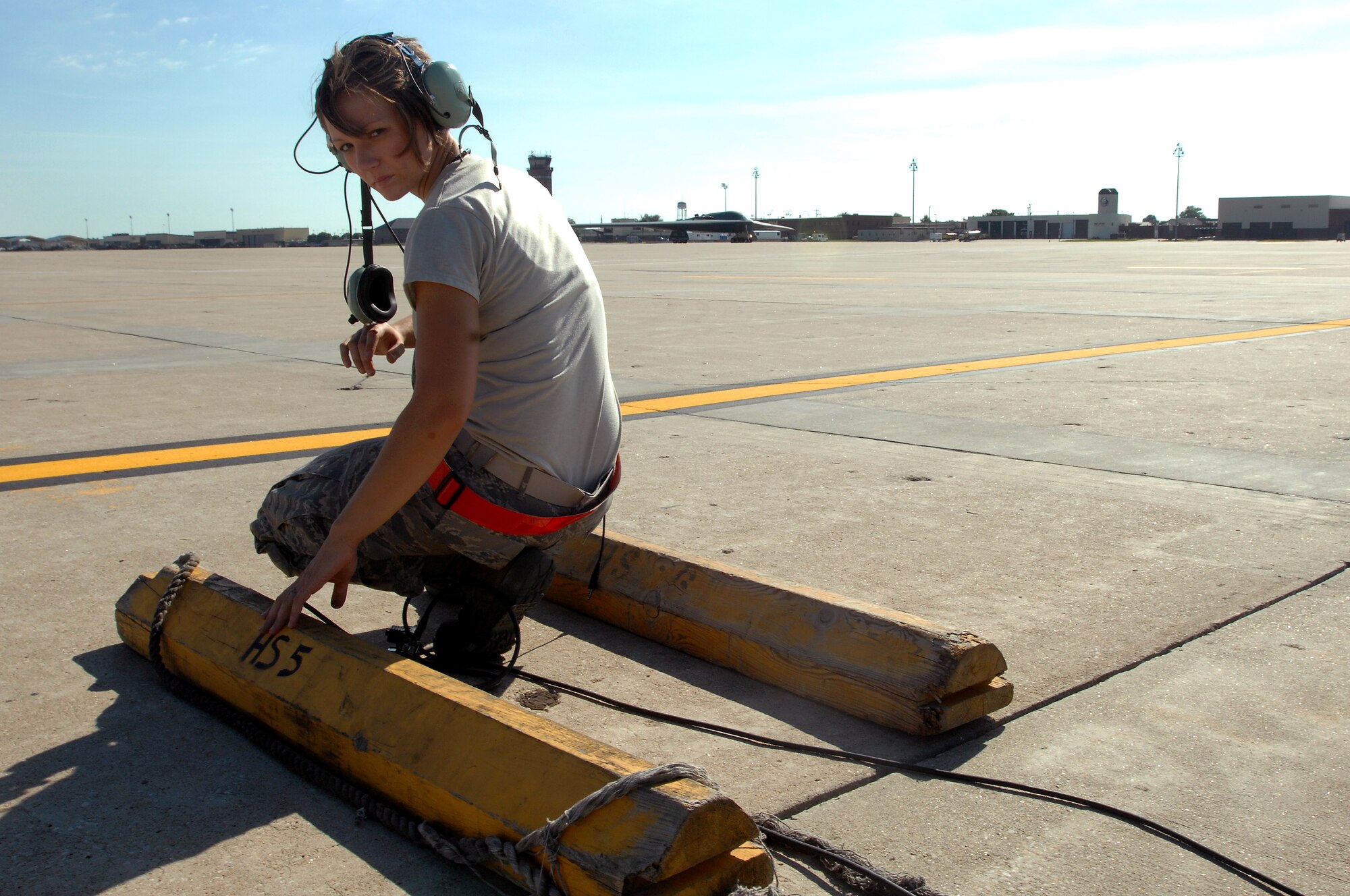 WHITEMAN AIR FORCE BASE, Mo. - Airman 1st Class Jaime Ibeh, 509th Aircraft Maintenance Squadron crew chief, waits in position in preparation to recover a B-2 Spirit, Aug. 24. 509th AMXS crew chiefs work around the clock with B-2 pilots training and staying prepared for real world missions. (U.S. Air Force photo/Senior Airman Kenny Holston)