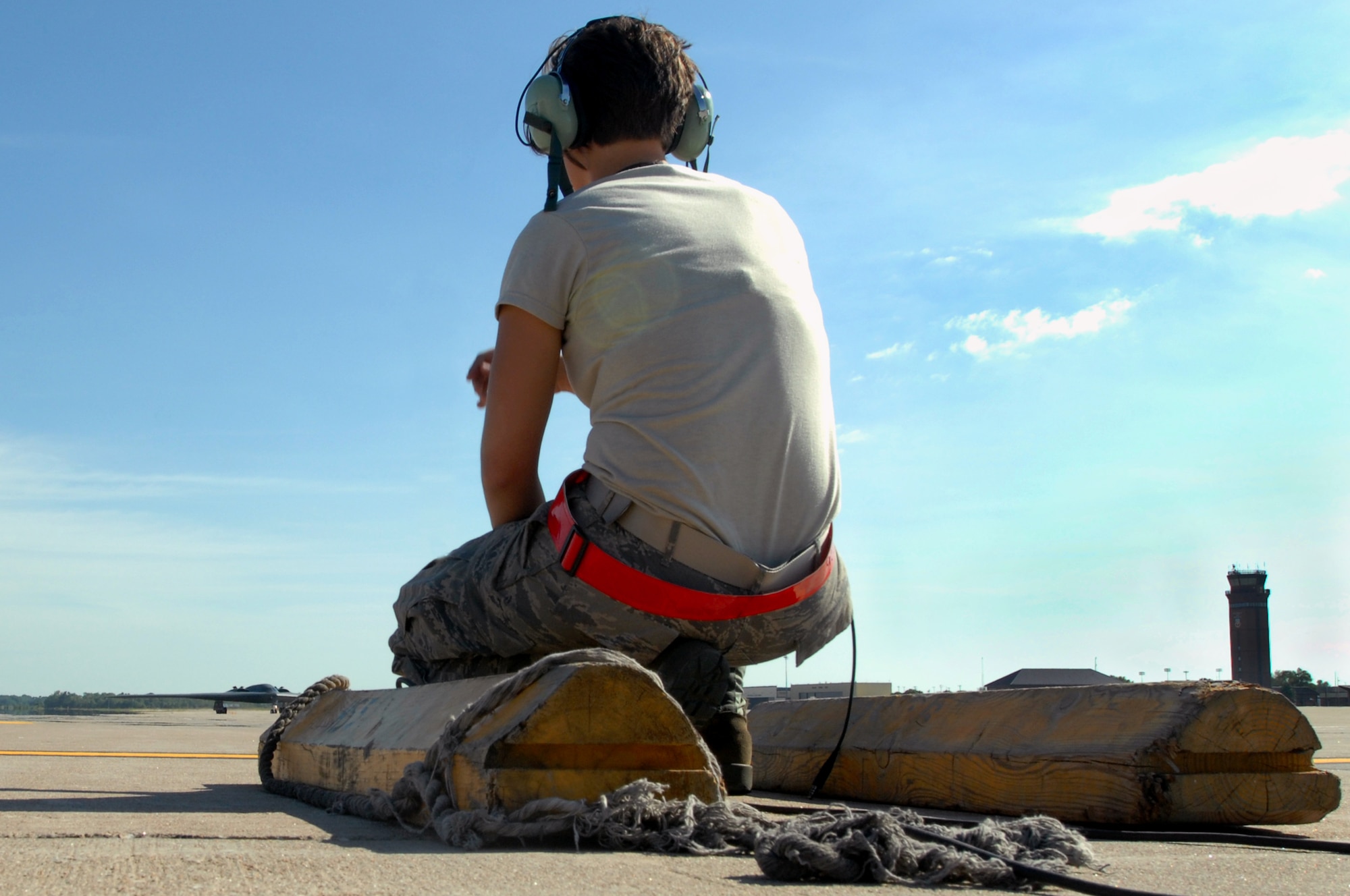 WHITEMAN AIR FORCE BASE, Mo. - Airman 1st Class Jaime Ibeh, 509th Aircraft Maintenance Squadron crew chief, waits in position in preparation to recover a B-2 Spirit, Aug. 24, 2009. 509th AMXS crew chiefs work around the clock with B-2 pilots training and staying prepared for real world missions. (U.S. Air Force photo/Senior Airman Kenny Holston)