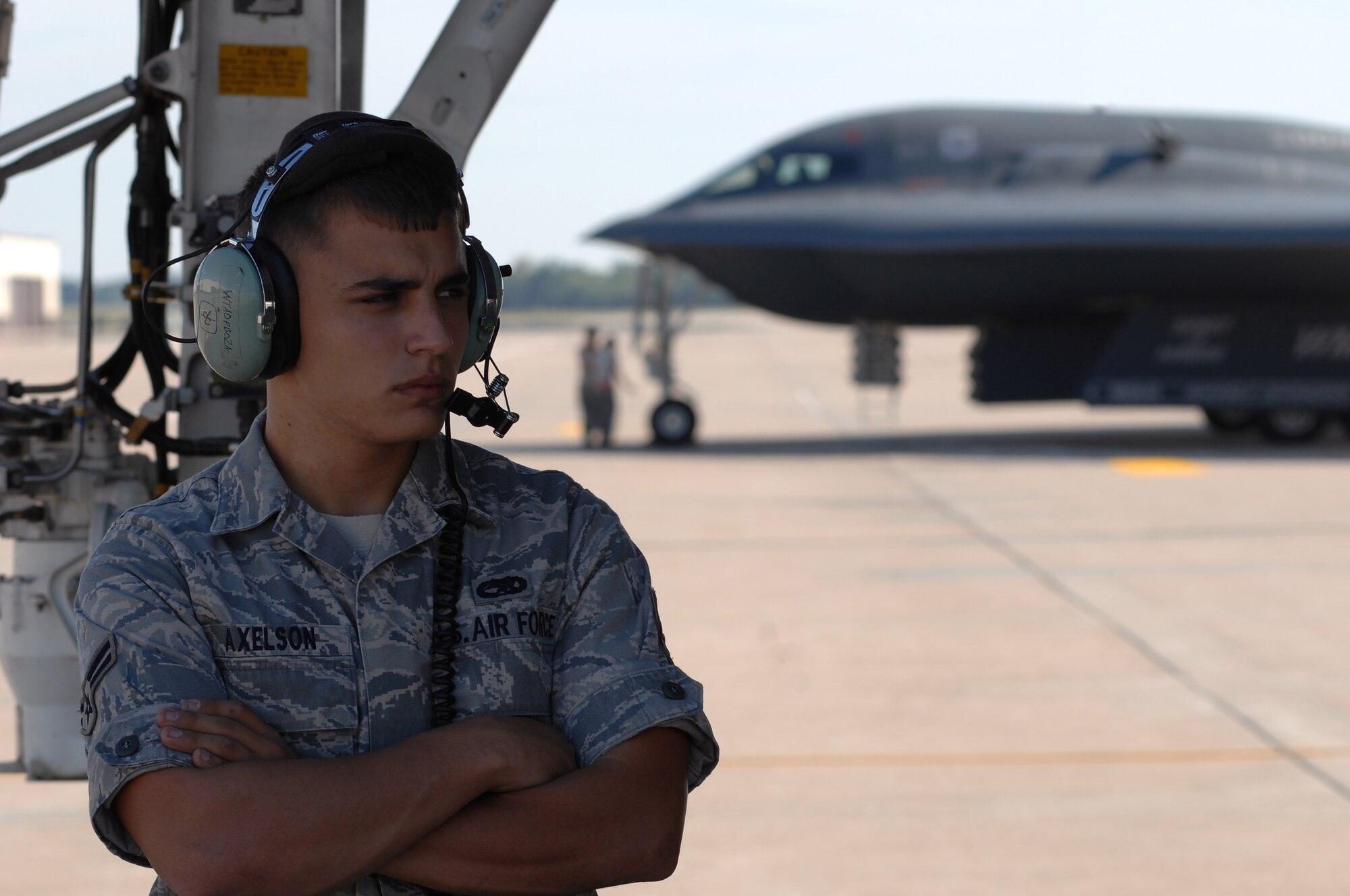 WHITEMAN AIR FORCE BASE, Mo. - Airman 1st Class Nathan Axelson, 509th Aircraft Maintenance Squadron crew chief, takes a break beneath a B-2 Spirit during preflight preparation, Aug. 24. Twenty B-2 Spirit aircrafts are assigned to the 509th Bomb Wing. The B-2's primary mission is to attack time-critical targets early in a conflict to minimize an enemy's war-making potential. (U.S. Air Force photo/Senior Airman Kenny Holston)