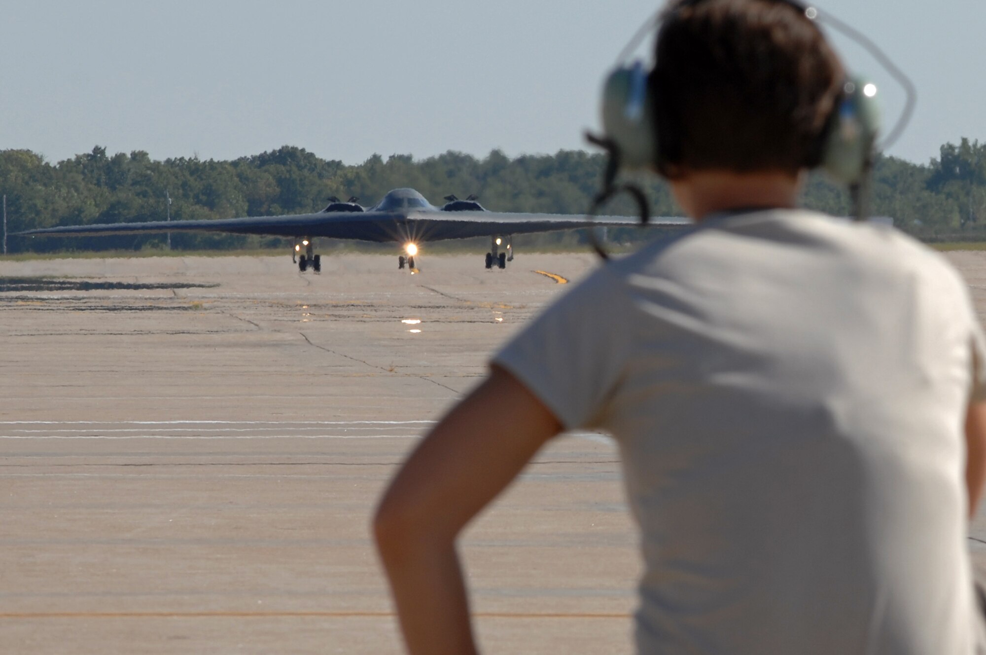 WHITEMAN AIR FORCE BASE, Mo. - Airman 1st Class Jaime Ibeh, 509th Aircraft Maintenance Squadron crew chief, waits in place to recover a B-2 Spirit after a mission, Aug. 24. 509th AMXS crew chiefs work around the clock with B-2 pilots training and staying prepared for real world missions. (U.S. Air Force photo/Senior Airman Kenny Holston)
