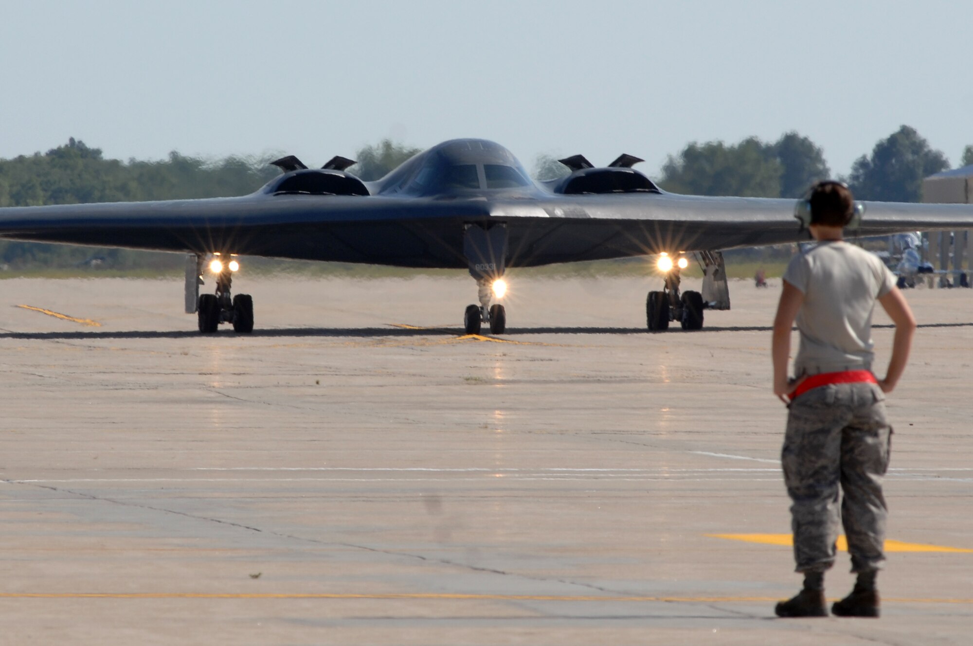 WHITEMAN AIR FORCE BASE, Mo. - Airman 1st Class Jaime Ibeh, 509th Aircraft Maintenance Squadron crew chief, waits in place to recover a B-2 Spirit after a mission, Aug. 24. 509th crew chiefs work around the clock with B-2 Spirit pilots training and staying prepared for real world missions. (U.S. Air Force photo/Senior Airman Kenny Holston)
