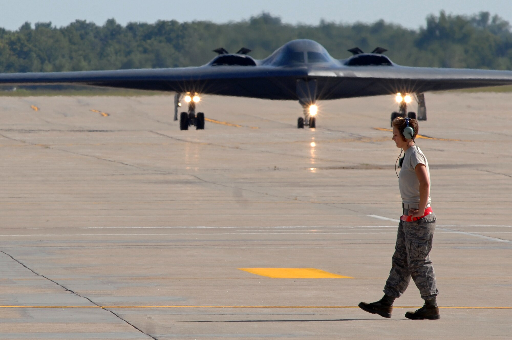 WHITEMAN AIR FORCE BASE, Mo. - Airman 1st Class Jaime Ibeh, 509th Aircraft Maintenance Squadron crew chief, moves into place in preparation to recover a B-2 Spirit after a mission, Aug. 24. 509th AMXS crew chiefs work around the clock with B-2 pilots training and staying prepared for real world missions. (U.S. Air Force photo/Senior Airman Kenny Holston)

