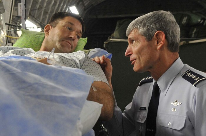 Gen. Norton Schwartz speaks with Tech. Sgt. Michael Williams after an aeromedical evacuation mission on the flightline at Andrews AFB, Md., Aug. 7. Sergeant Williams was recently injured in Afghanistan and is currently receiving treatment at Walter Reed Army Medical Center, Washington. General Schwartz is Chief of Staff of the Air Force and Sergeant Williams is an explosives ordnance disposal technician with the 437th Civil Engineer Squadron. (U.S. Air Force photo/Staff Sgt. Renae L. Kleckner)