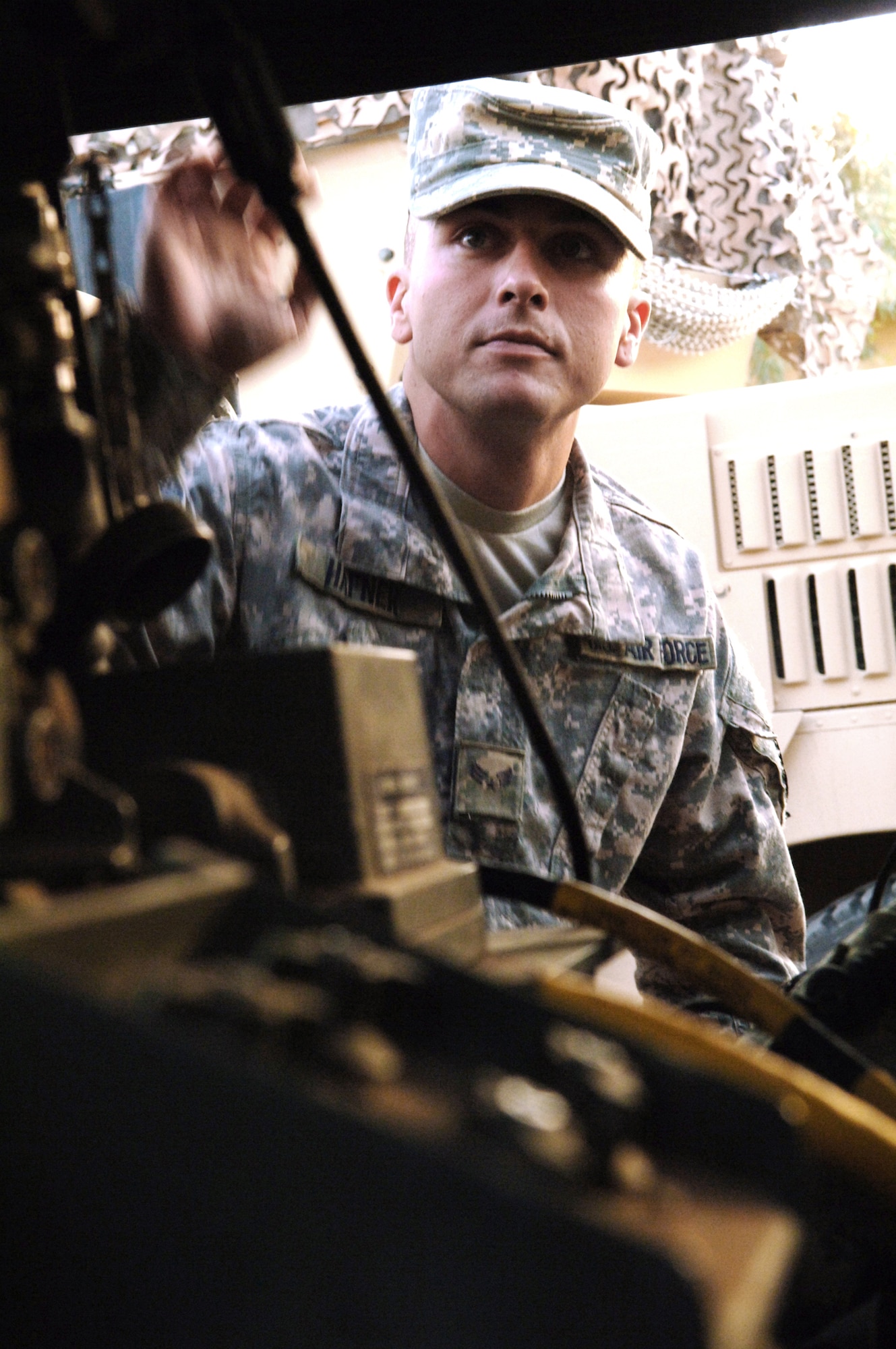 Senior Airman Brian Hafner inspects his equipment and vehicle on the 532nd Expeditionary Security Forces Squadron's quick reaction force compound Aug. 20 at Joint Base Balad, Iraq prior to a patrol for combative activity off base. Airman Hafner has completed the Defender's Edge program during his time here at Joint Base Balad and uses techniques he learned there to deal with post-traumatic stress disorder symptoms. Airman Hafner is a member of the 532nd ESFS's quick reaction force. (U.S. Air Force photo/Senior Airman Andria J. Allmond) 
