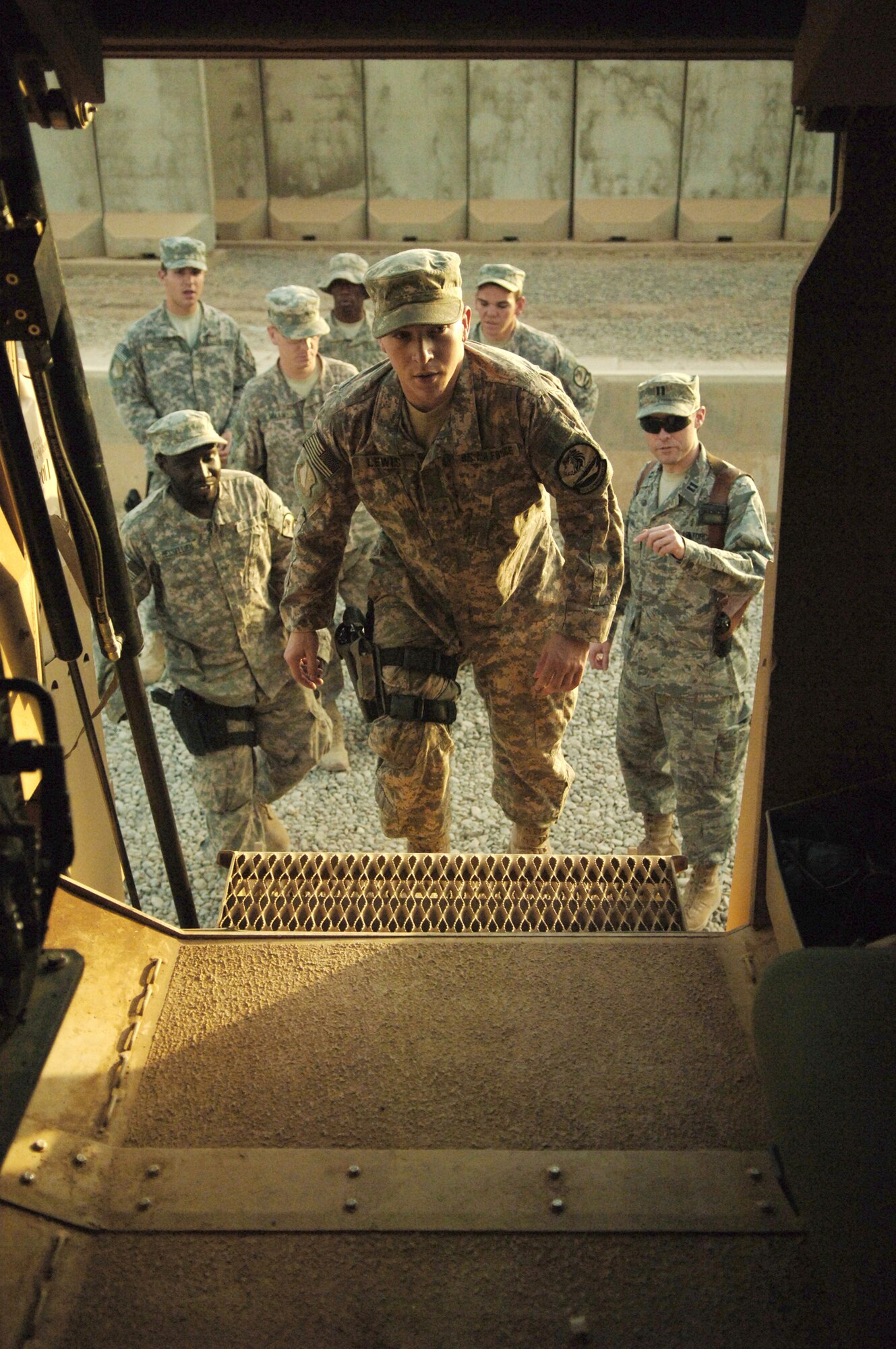 Capt. Craig Bryan (far right) briefs a group of 532nd Expeditionary Security Forces Squadron's quick reaction force Airmen while they board a mine resistant ambush protected vehicle as part of a combat-stress therapy scenario Aug. 20 at Joint Base Balad, Iraq. Captain Bryan has worked with members of the 532nd ESFS, who conduct operations outside the wire, in an effort to improve their mental resiliency to combat-related stressors. Captain Bryan is the 332nd Expeditionary Aerospace Medicine Squadron traumatic brain injury clinic director. (U.S. Air Force photo/Senior Airman Andria J. Allmond) 