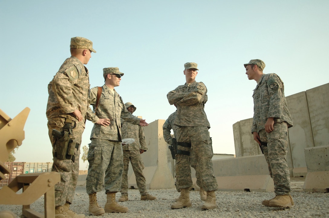 Capt. Craig Bryan (second from left) briefs a group of 532nd Expeditionary Security Forces Squadron's quick reaction force Airmen prior to conducting a combat-stress therapy scenario Aug. 20 at Joint Base Balad, Iraq. Captain Bryan has worked with members of the 532nd ESFS, who conduct operations outside the wire, in an effort to improve their mental resiliency to combat-related stressors. Captain Bryan is the 332nd Expeditionary Aerospace Medicine Squadron traumatic brain injury clinic director. (U.S. Air Force photo/Senior Airman Andria J. Allmond) 