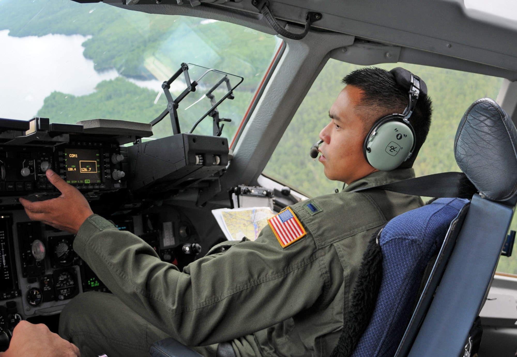 First Lt. Onef Reyes, a C-17 Globemaster III pilot with the Air Force Reserve Command's 512th Airlift Wing at Dover Air Force Base, Del., flies a training mission during a visit to 8 Wing at Canadian Forces Base Trenton, Ontario.  Ten reservists from Dover flew to the Canadian base to spend three days with Royal Canadian Air Force members to forge a partnership and identify future training opportunities for flying, aerial port operations, airlift control and maintenance procedures.  (U.S. Air Force photo/Capt. Marnee A.C. Losurdo)