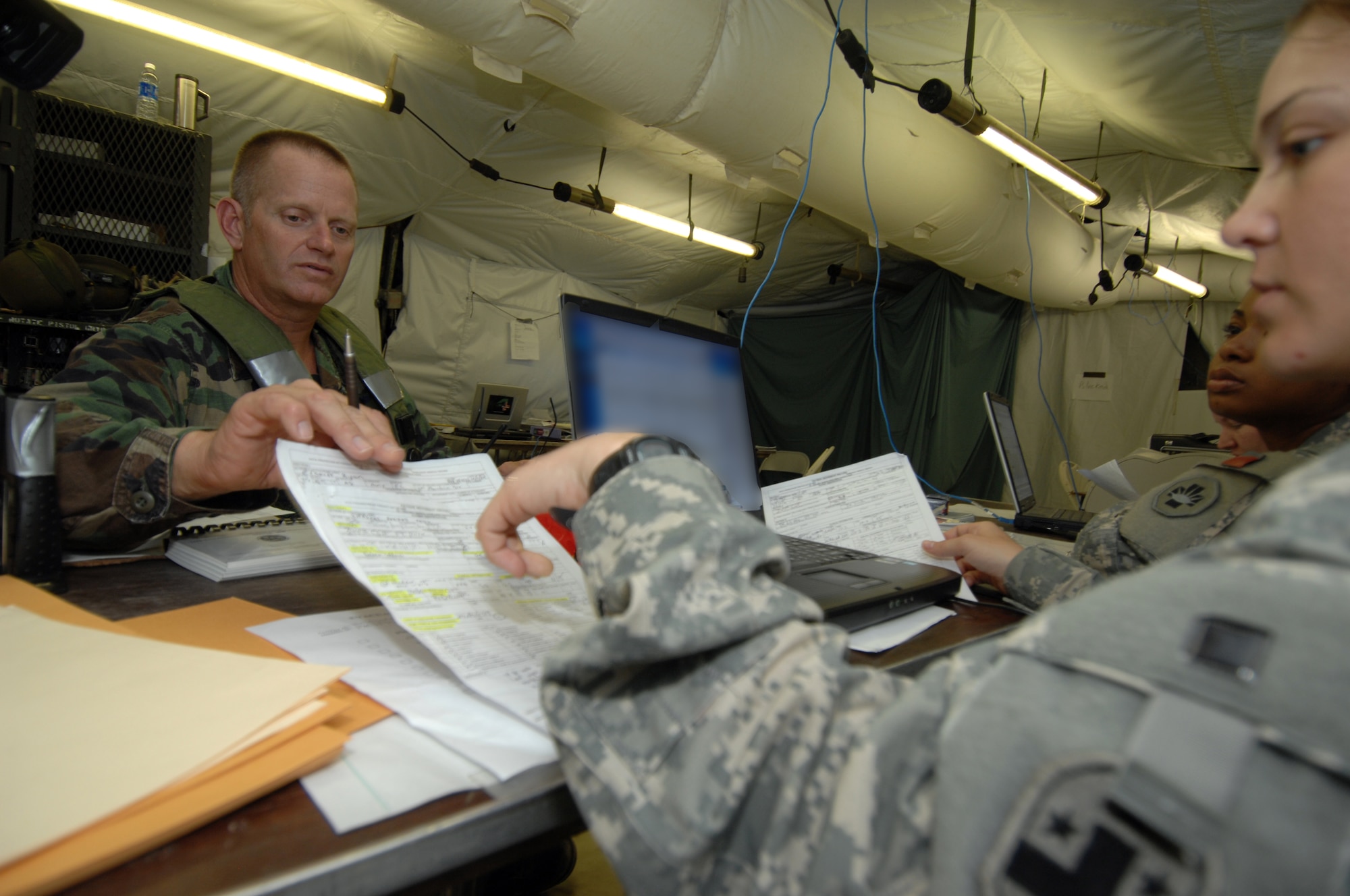 Aeromedical evacuation Airmen from Air Mobility Command and Army medical Soldiers work together during the Joint Readiness Training Center Exercise 09-09 on Aug. 21, 2009, at Fort Polk, La.  AMC Airmen supported the exercise in a variety of roles to include AE, airlift and contingency response.  (U.S. Air Force Photo/Senior Airman Jimmy L. Dang)