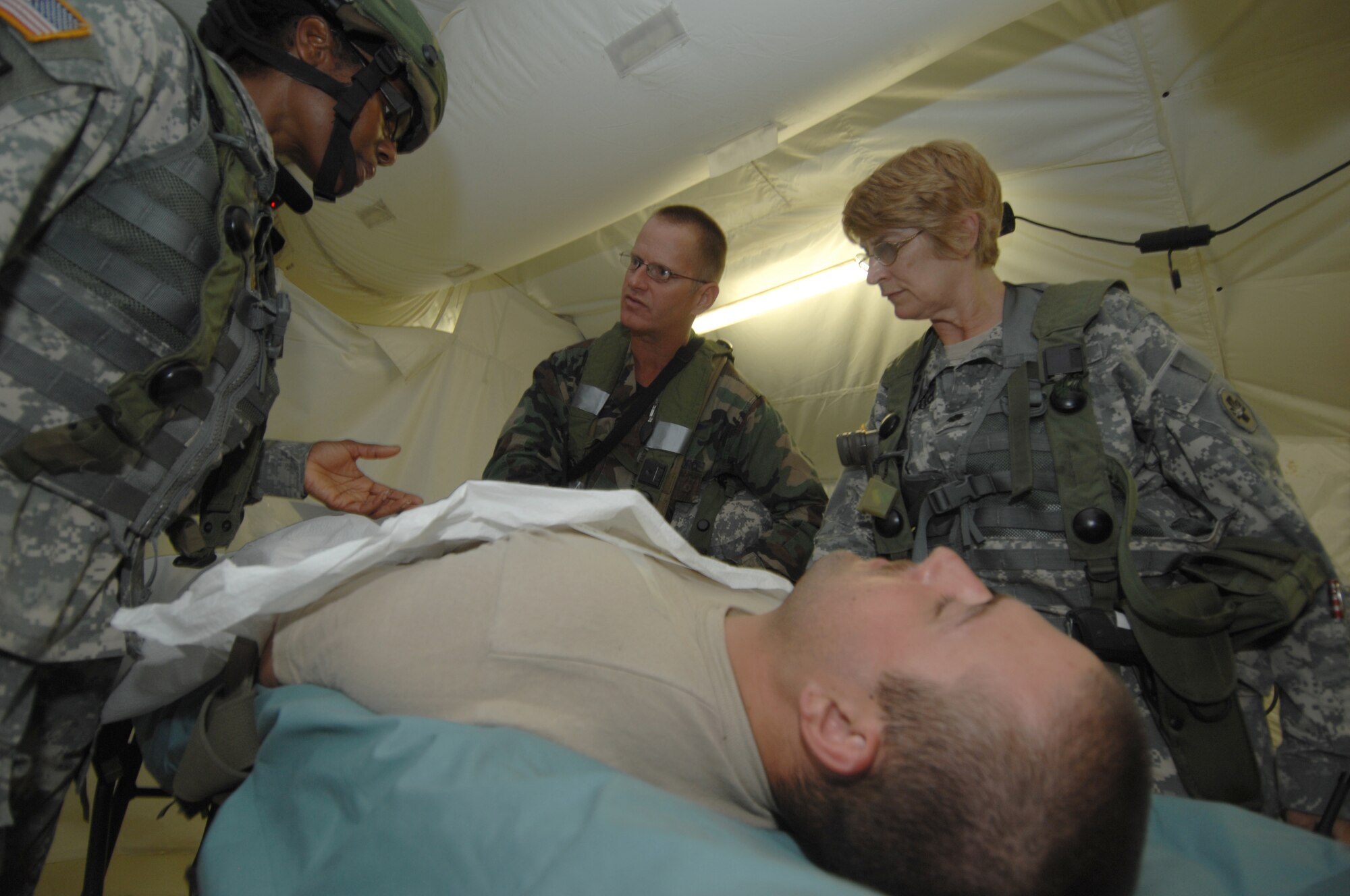 Airmen and Soldiers work together in the combat support hospital during action in the Joint Readiness Training Center Exercise 09-09 on Aug. 19, 2009, at Fort Polk, La.  JRTC provides realistic training using scenarios that allow integration between joint military organizations, host nations and civilian role players. Units from the Air Force, Army, Marine Corps and the Canadian and Belgian air forces trained together during the exercise to provide quality care to sick and injured personnel in real-world environments. (U.S. Air Force Photo/Senior Airman Jimmy L. Dang)
