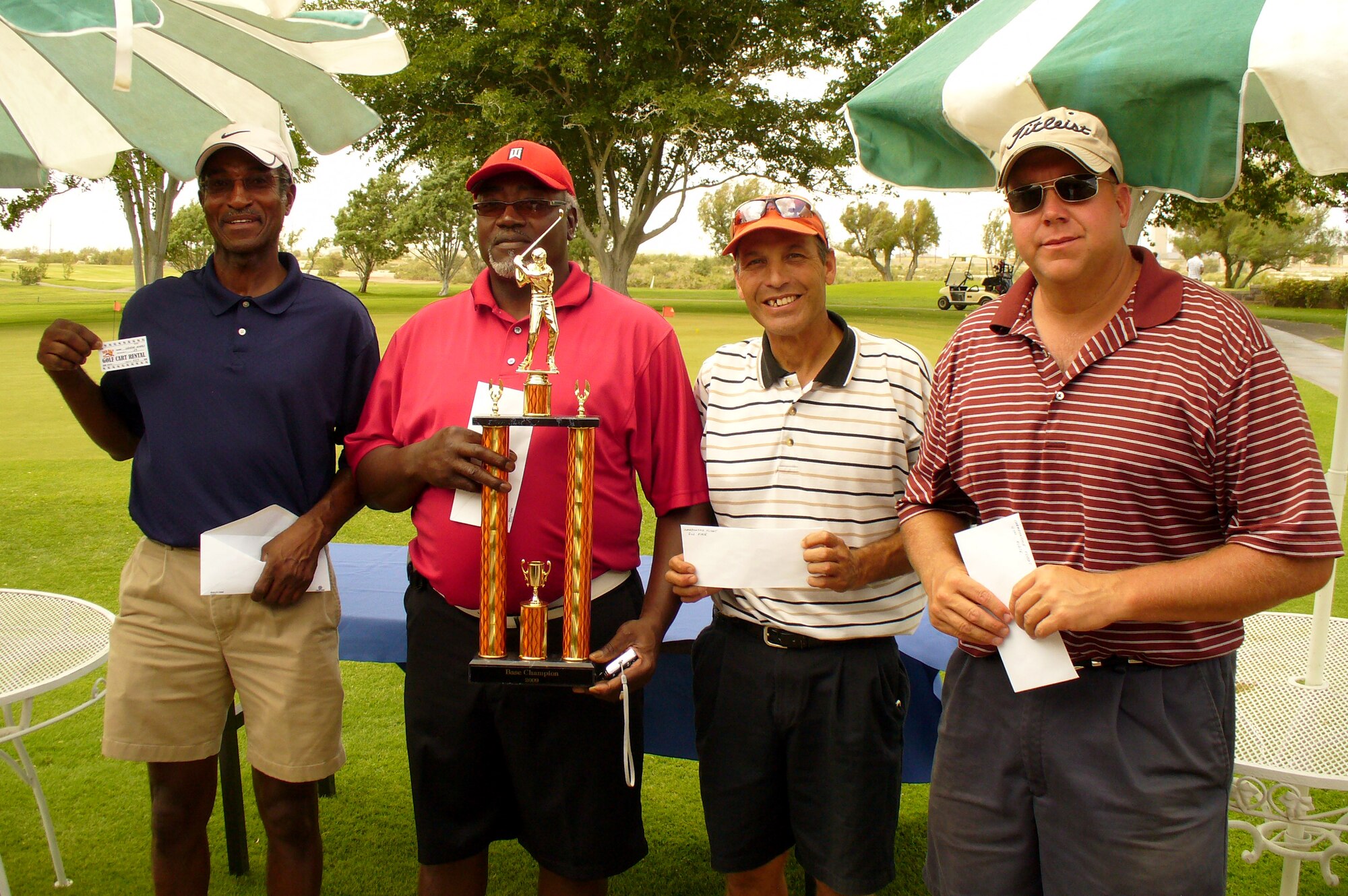 HOLLOMAN AIR FORCE BASE, N.M. -- The four individuals who placed in the top four in the 2009 base golf championship pose for a photo after the tournament at the Apache Mesa Golf Course here Aug. 23. The individuals (from left to right) are George Morris, who placed third overall, Tommie Williams, first overall, Ralph Aegan, second, and John Gibson, fourth. (Photo provided by Patrick Mahoney, Director of Golf, Apache Mesa Golf Course)