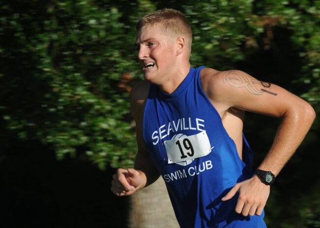Yale Akers finishes the 5,000-meter running portion of a triathlon held here Aug. 22. Akers finished his run with a time of 25 minutes, 39 seconds and placed 21st in the triathlon out of 54 competitors. Akers is a composite tool kit specialist for flightline support with the 437th Aircraft Maintenance Squadron . (U.S. Air Force photo/Senior Airman Katie Gieratz)