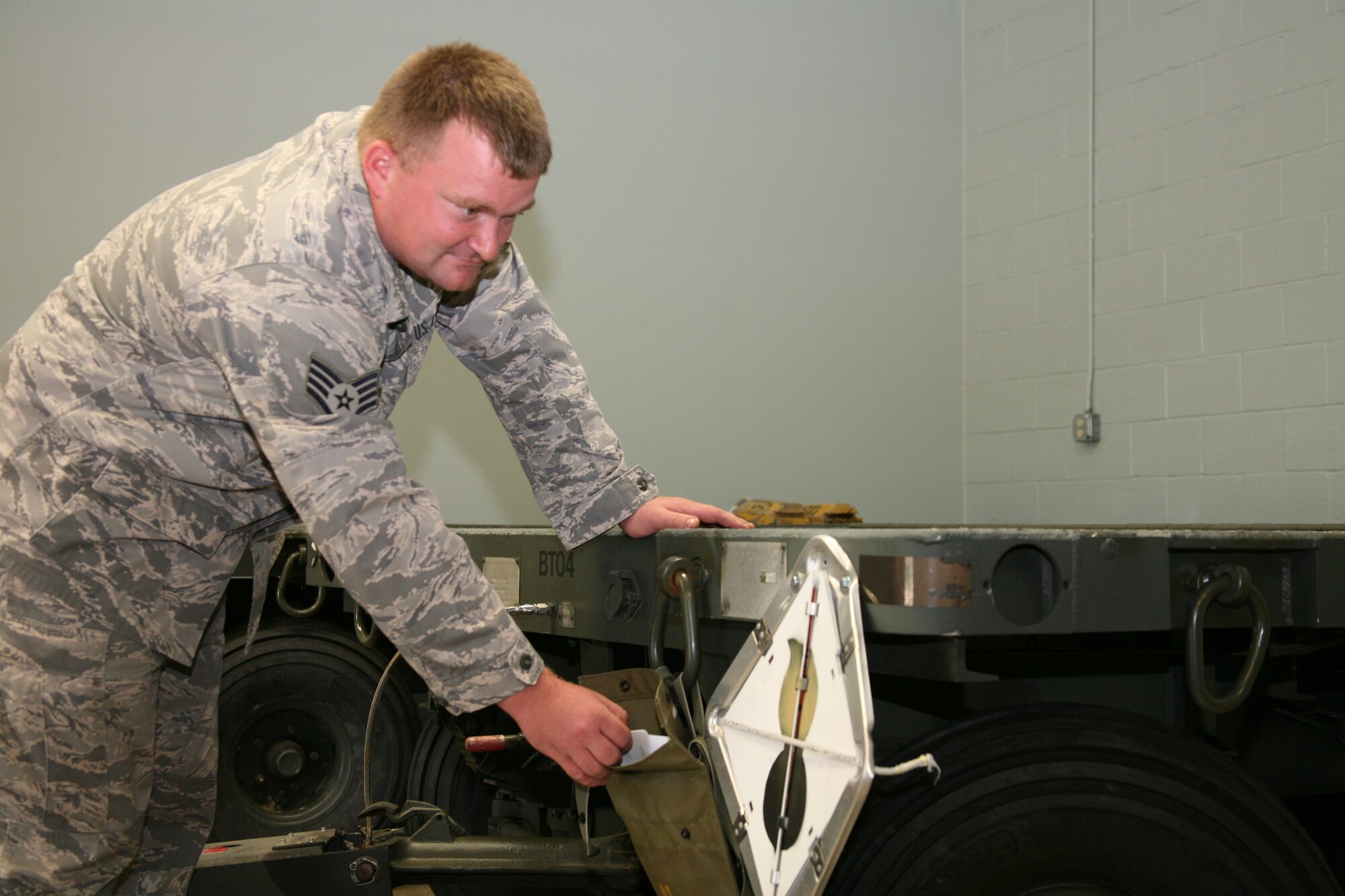 Staff Sgt. Daniel Heyer, 19th Equipment Maintenance Squadron’s munitions flight, checks the paperwork on a trailer used to haul munitions. The 40 members of the munitions flight support Combat Airlifters on a daily basis, issuing rifle and pistol rounds for Airmen to fire during qualification training or storing plastic explosives for the explosive ordnance disposal shop until a threat needs to be neutralized. (U.S. Air Force photo by Bob Oldham)