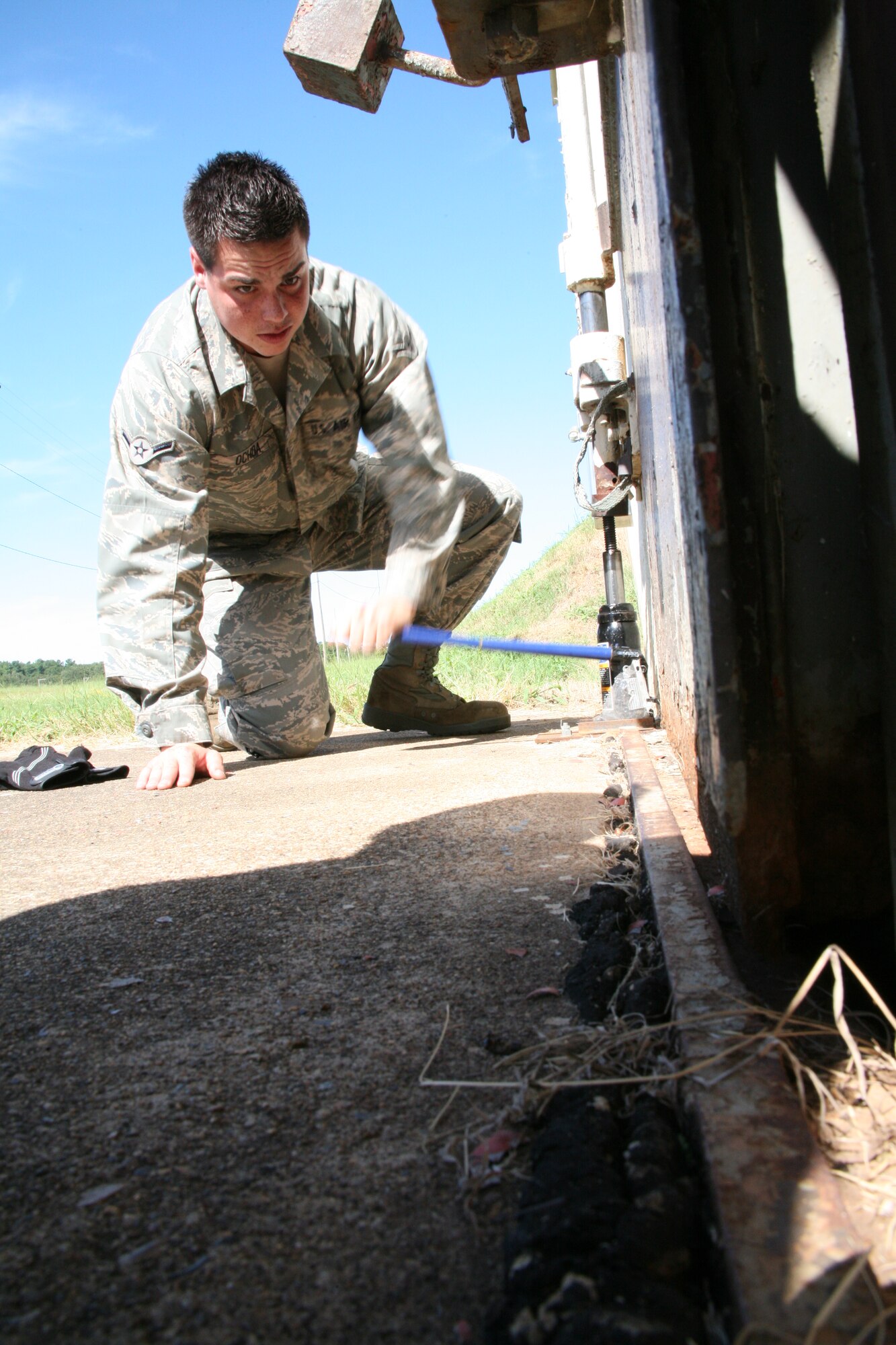Airman Alex Ochoa, 19th Equipment Maintenance Squadron’s munitions flight, jacks up a door to a storage igloo. The door is a holdover from an era when the base was host to the 308th Strategic Missile Wing and its Titan II intercontinental ballistic missiles. The 40 members of the munitions flight support Combat Airlifters on a daily basis, issuing rifle and pistol rounds for Airmen to fire during qualification training or storing plastic explosives for the explosive ordnance disposal shop until a threat needs to be neutralized. (U.S. Air Force photo by Bob Oldham)