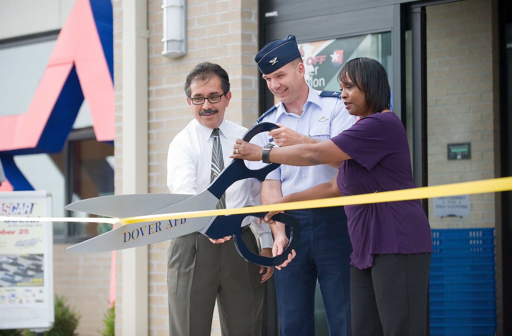 (From left) Jose Mendez, Fort George G. Meade Army and Air Force Exchange Service general manager; Col. Manson Morris, 436th Airlift Wing commander; and Connie Hayman, Southside Service Station manager, cut the ribbon on the new Southside Service Station Aug. 24.