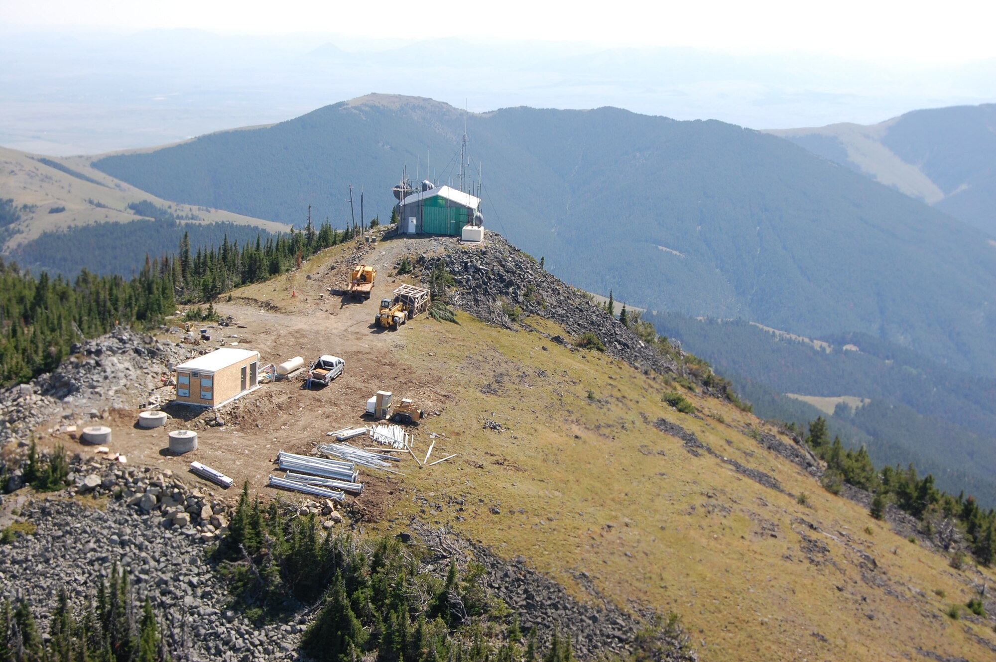 The new antenna and radio site atop Highwood Baldy Mountain roughly 40 miles northeast of Great Falls is the latest joint project between the Air Force and Montana Army National Guard.  A CH-47 Chinook helicopter carried the last shipment of four microwave dishes Aug. 21 in support of the Wide Area Coverage Project supported by Air Force Space Command. The project brings Air Force and Montana communication capabilities into the 21st Century through digital communication. The microwave dishes will be installed on a 100-foot tower that was brought up in 20-foot sections.  The MANG completed 50 lifts in a two week time frame. Today was the culmination of the last airlift. The new antenna will also support Choteau, Cascade and Judith Basin counties; Montana Highway Patrol; Montana Department of Transportation; local law enforcement agencies; and first-responders. (U.S. Air Force photo/Staff Sgt. Eydie Sakura)