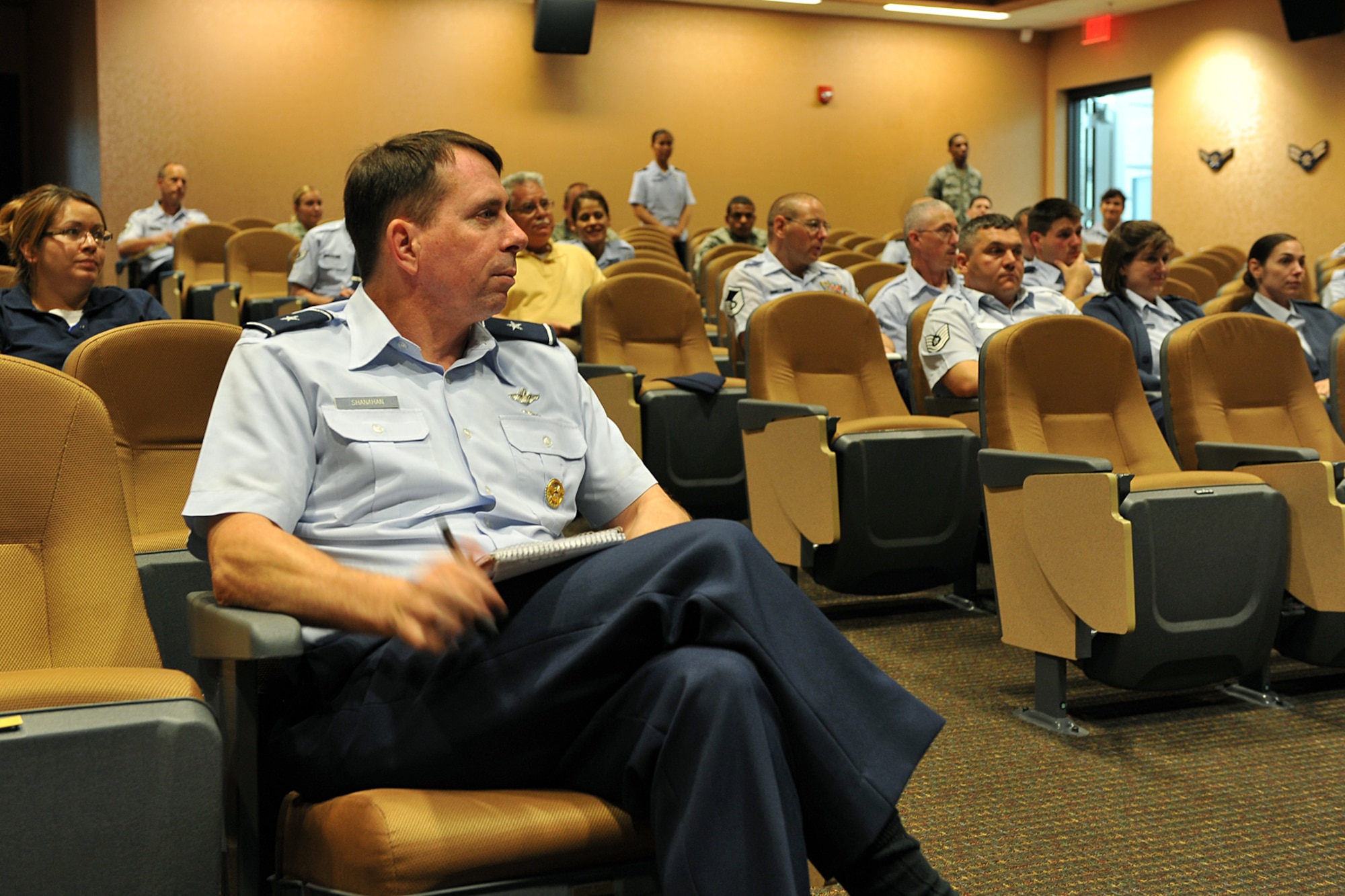 OFFUTT AIR FORCE BASE, Neb. -- Brig. Gen. John N.T. Shanahan, 55th Wing commander, along with members of the Fightin' Fifty-Fifth listen to the Air Force Personnel Center's Spread the Word briefing at the Air Force Weather Agency auditorium here Aug. 24. The briefing covered numerous topics including assignments, deployments and civlian hiring procedures. U.S. Air Force Photo by Charles Haymond 