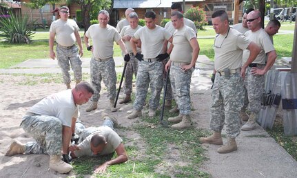 SOTO CANO AIR BASE, Honduras — Sergeant 1st Class Robert Robinson, class instructor, demonstrates an advanced baton take-down technique during the nonlethal training here Aug. 20 at the JSF compound. Sergeant Robinson also taught the JSF members pressure point control and riot control during the training (U.S. Air Force photo/Staff. Sgt. Chad Thompson).